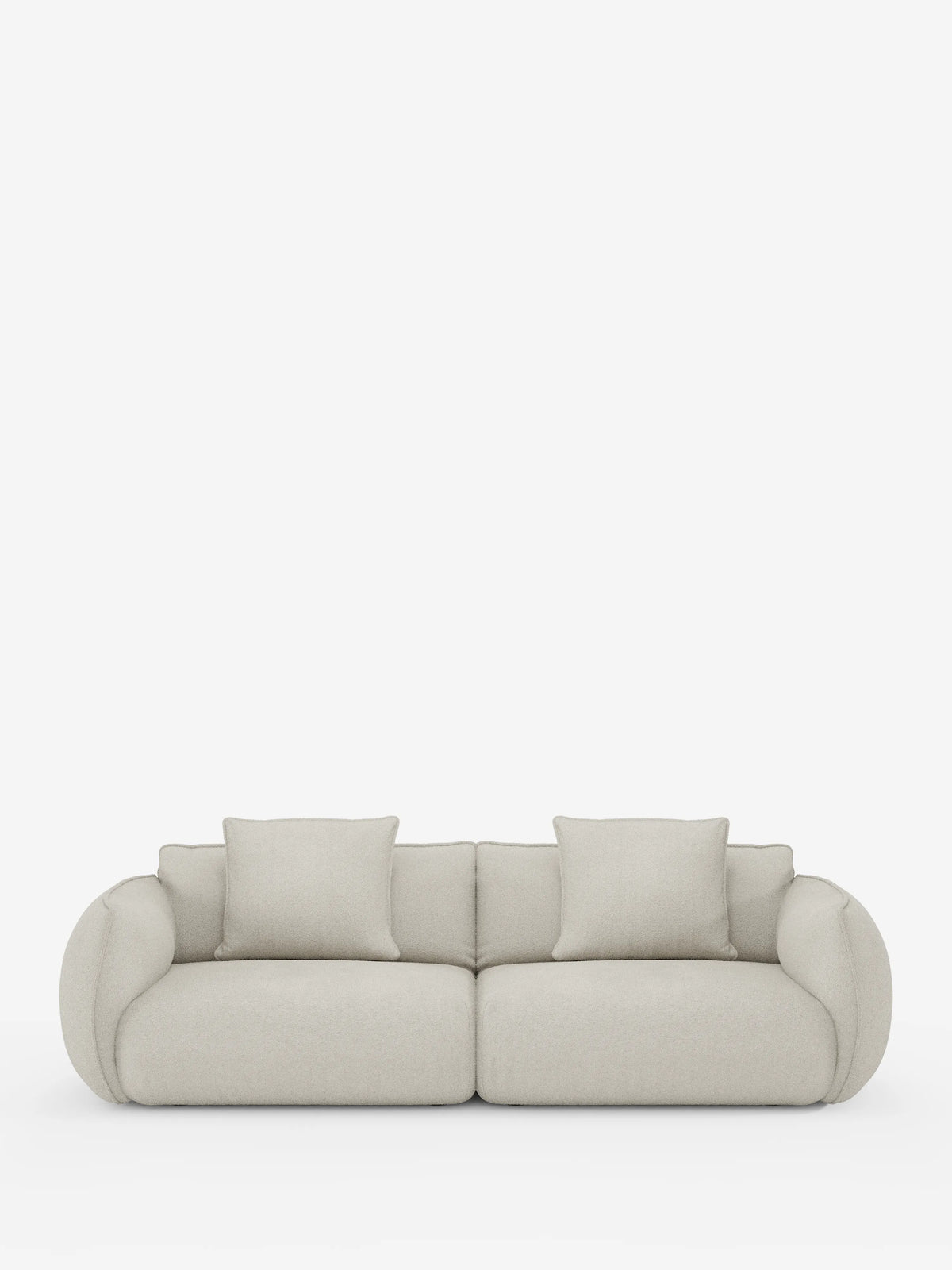 Un moderno divano modulare a 3 posti Nimbus di Divani.Store, rivestito in tessuto effetto cotone (t33) di colore beige chiaro e resistente alle macchie, dotato di due ampi cuscini di seduta e due cuscini dello schienale. I braccioli arrotondati e di grandi dimensioni conferiscono al divano un aspetto lussuoso e accogliente. Il divano è esposto su uno sfondo bianco a tinta unita.