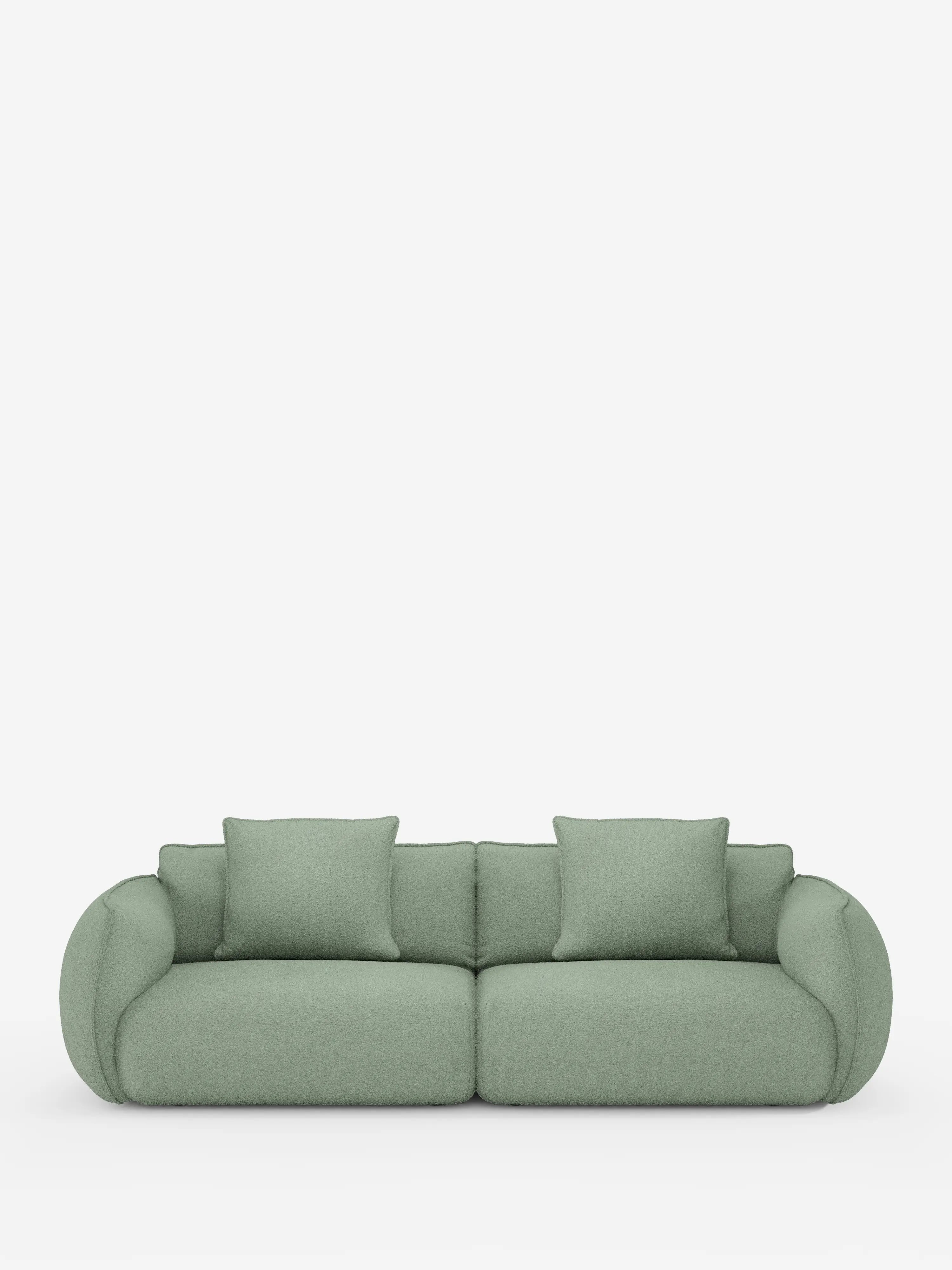 Un divano Nimbus contemporaneo a 3 posti, modulare e componibile, di Divani.Store, realizzato in tessuto effetto cotone (t33) di colore verde chiaro e resistente alle macchie, caratterizzato da un design arrotondato e imbottito. Comprende due ampi cuscini di seduta, due cuscini dello schienale e braccioli curvi. Presentato su uno sfondo bianco a tinta unita per esaltare lo stile morbido e moderno del divano.