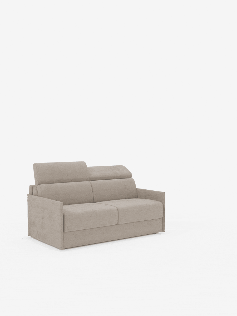 Un divano letto Miryam beige di Divani.Store, dotato di poggiatesta reclinabili, comfort maxi e braccioli dritti, dal design compatto e rivestito in morbido tessuto smacchiabile T31, è collocato al centro di uno spazio bianco quasi completamente vuoto. Lo stile minimal contemporaneo e l’aspetto lussuoso del divano creano un elegante contrasto con lo sfondo spoglio.