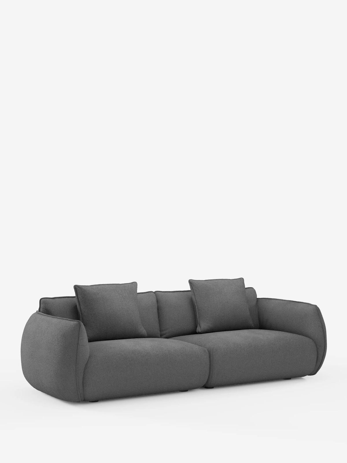 Vi presentiamo il divano modulare e componibile a 3 posti Nimbus di Divani.Store, un divano moderno di colore grigio scuro che misura 250 cm. Rivestito in tessuto effetto cotone (t33) resistente alle macchie e sfoderabile, questo modello presenta bordi morbidi e arrotondati e quattro grandi cuscini coordinati. Su uno sfondo bianco a tinta unita, la sua silhouette minimalista si distingue per il profilo basso e l’aspetto morbido e accogliente, perfetto per gli spazi abitativi contemporanei.