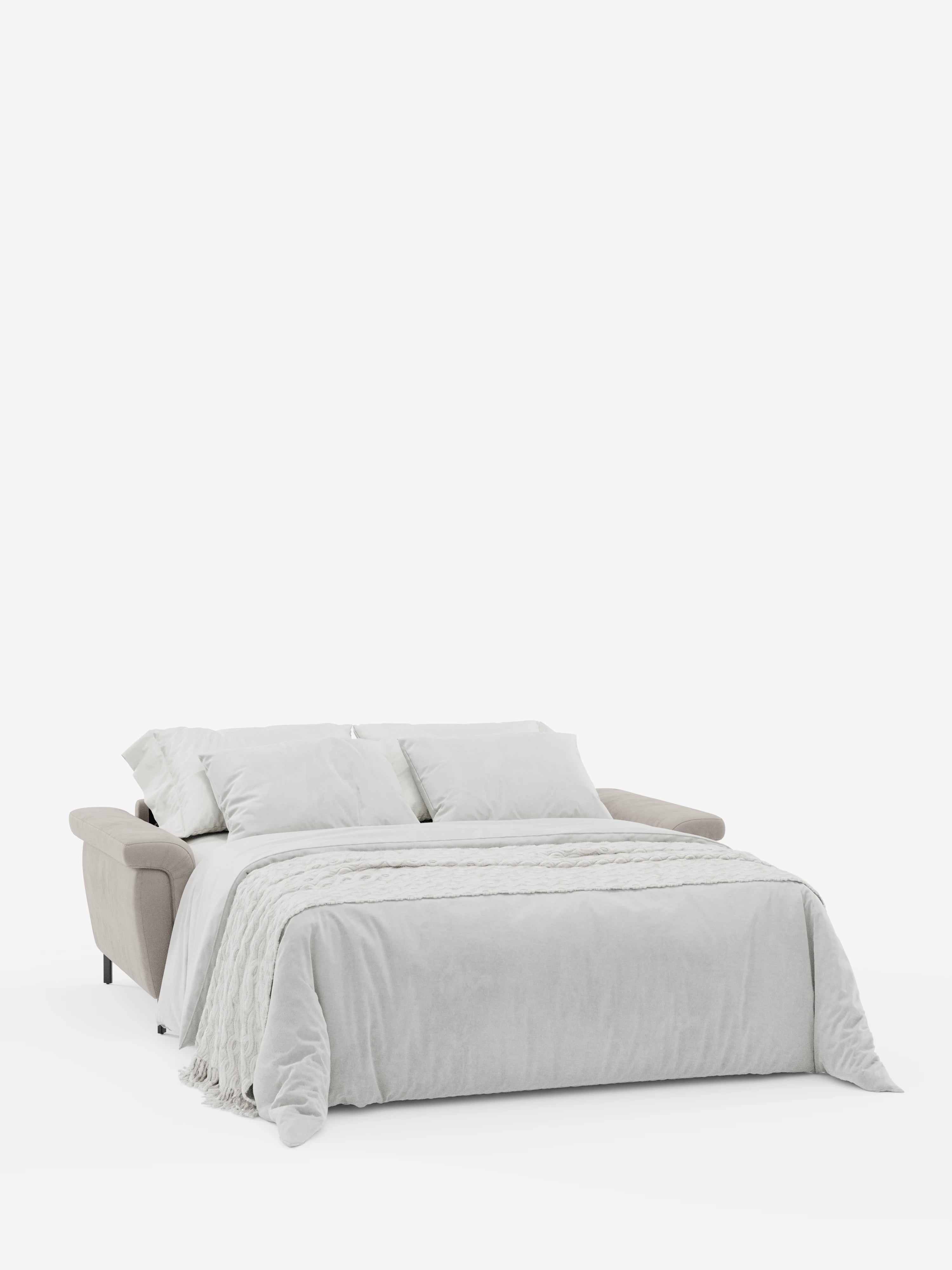 Un divano letto di design Capri color beige con piedini alti e poggiatesta reclinabili di Divani.Store è aperto in modalità letto, rivestito con biancheria da letto grigio chiaro e completato da due morbidi cuscini e una coperta. Lo sfondo bianco mette in risalto il design moderno e lineare, nonché le morbide trame del raffinato tessuto effetto velluto smacchiabile T30 del divano.