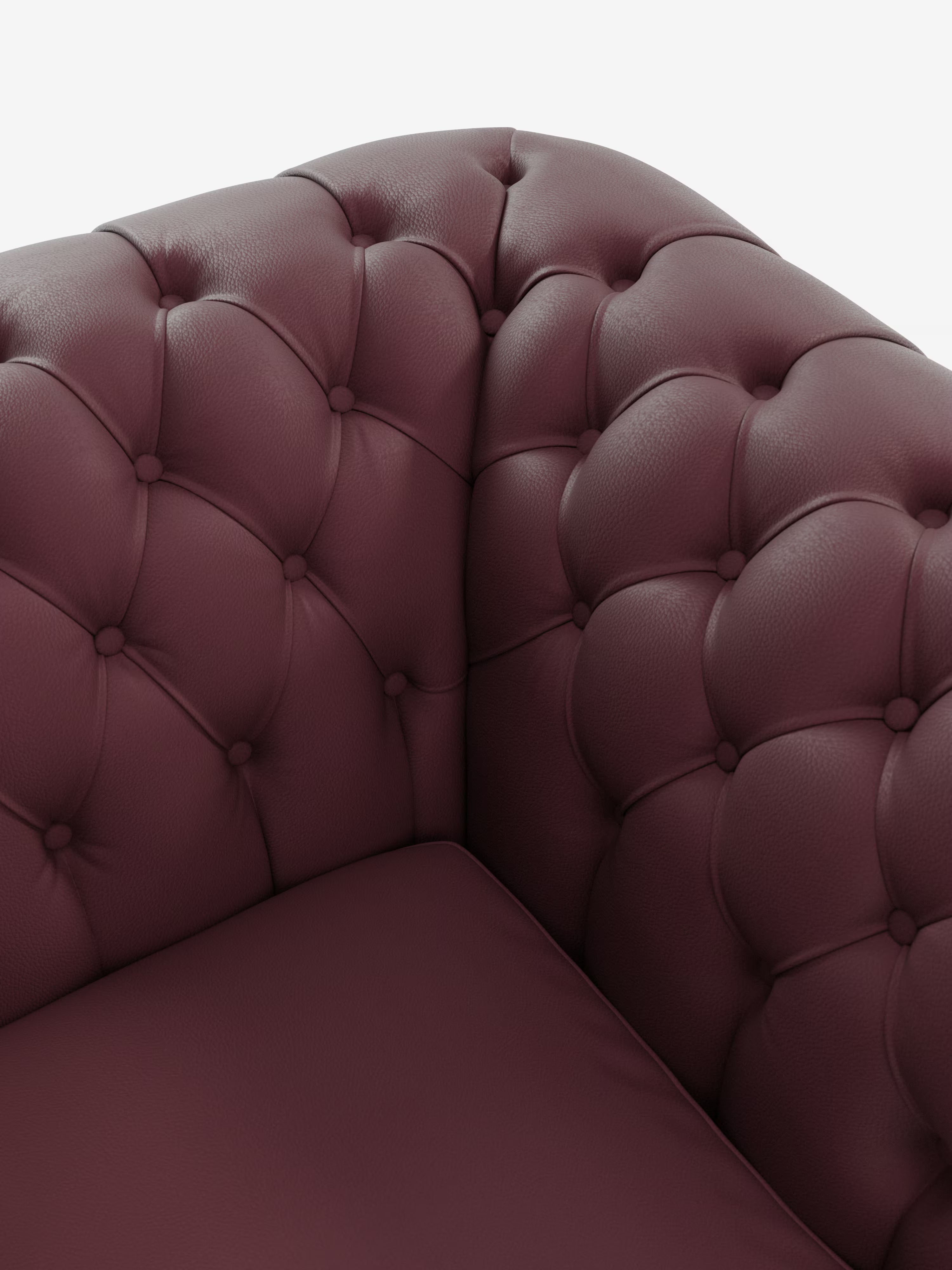 Primo piano di una poltrona Chester color bordeaux in vera pelle spessorata con capitonné artigianale di Divani.Store, che mette in risalto l’angolo in pelle trapuntata con profondi bottoni decorativi e un rivestimento morbido e materico. Il bracciolo e lo schienale si incontrano ad angolo retto, mettendo in risalto l’imbottitura soffice e la silhouette delicatamente ricurva — un elegante esempio della classica maestria artigianale Chesterfield — su uno sfondo bianco a tinta unita.