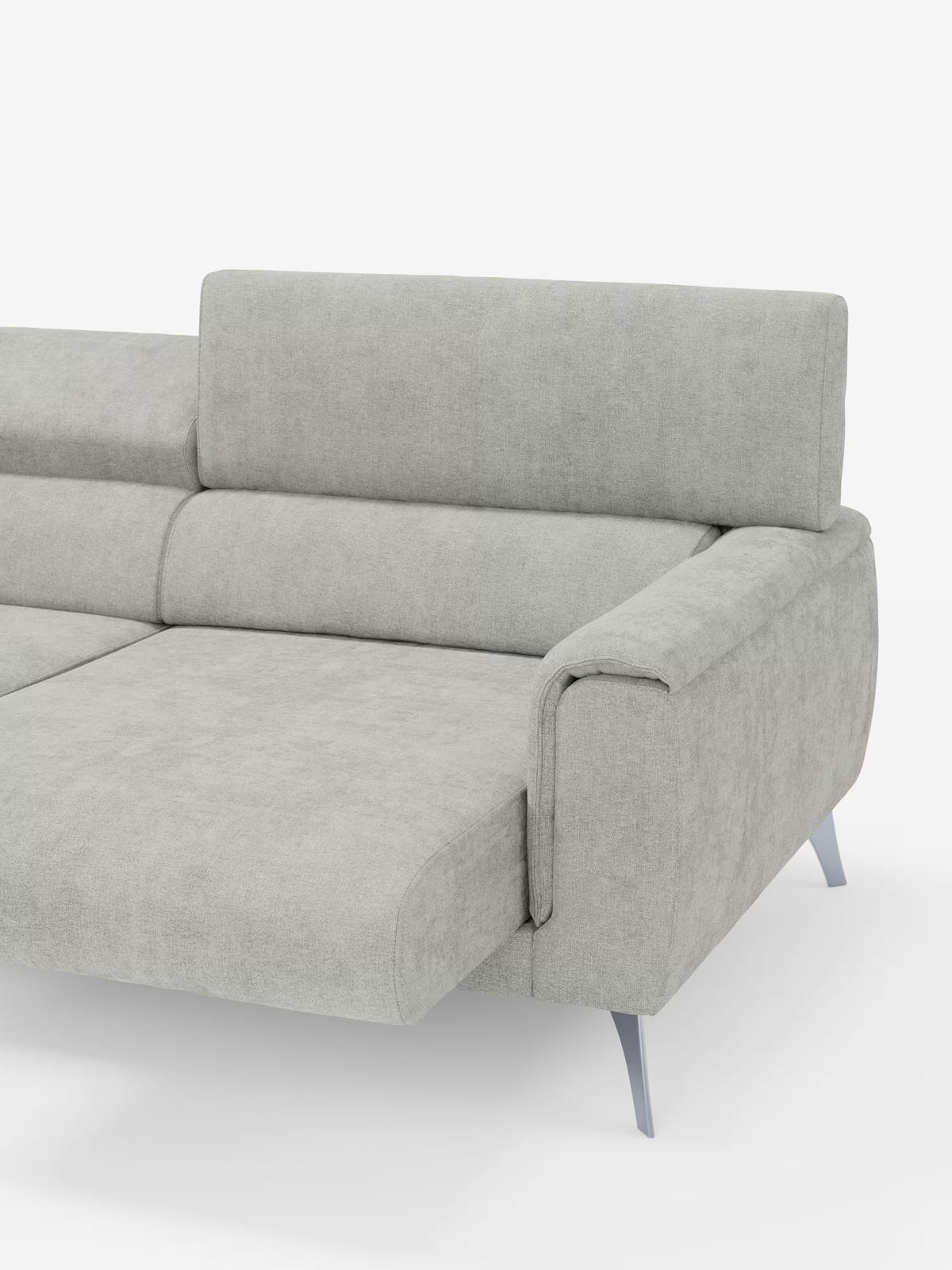 Un divano contemporaneo Caravaggio a 2 e 3 posti di Divani.Store, realizzato in elegante tessuto T31 grigio chiaro resistente alle macchie, dotato di sedute allungabili, poggiatesta reclinabili, ampi braccioli imbottiti e raffinate gambe in metallo angolate. Ideale per un salotto moderno, il divano è presentato su uno sfondo bianco a tinta unita, che ne mette in risalto il lato sinistro e parte della chaise longue estesa.