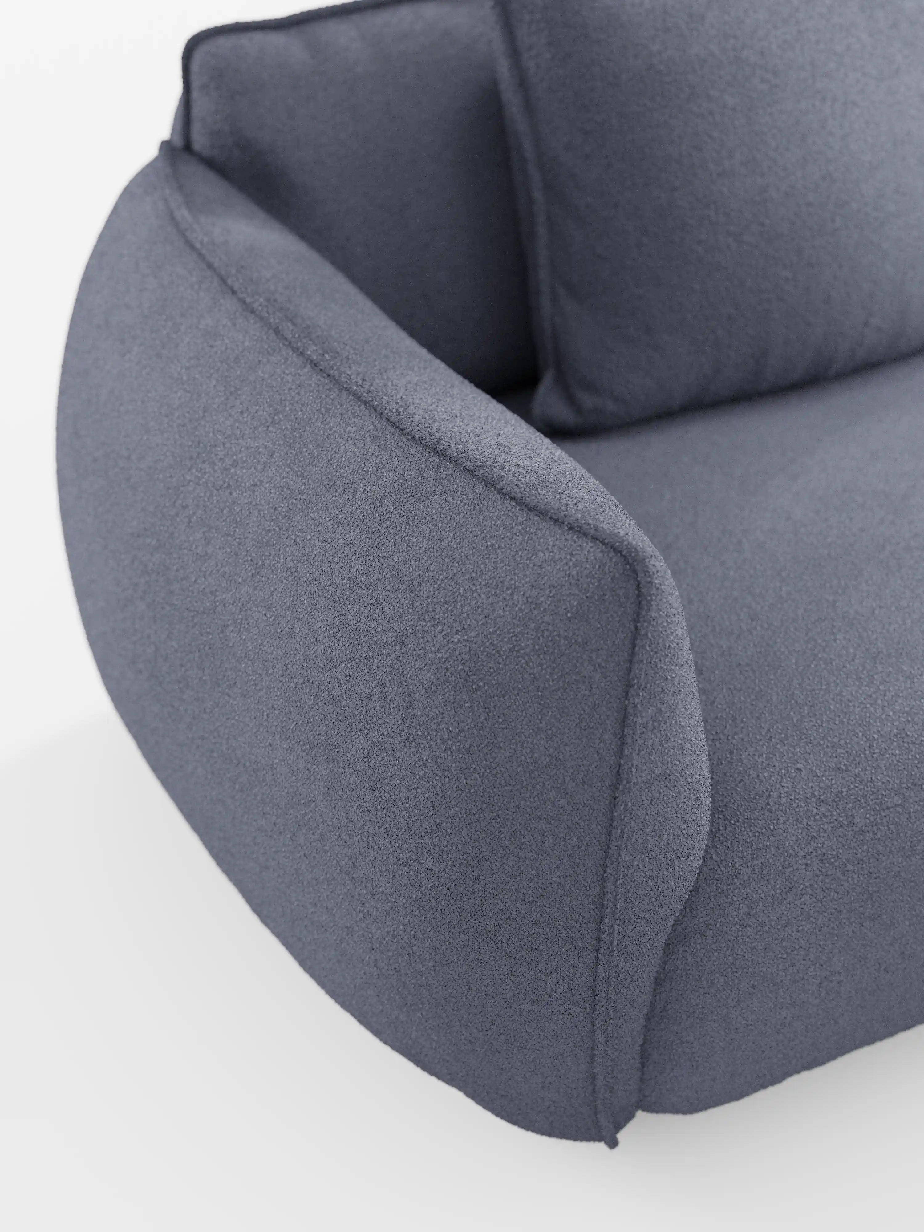 Primo piano del bracciolo sinistro e della seduta del divano Nimbus a 3 posti, modulare e componibile da 250 cm di Divani.Store, rivestito in tessuto t33 dall’effetto cotone, testurizzato e resistente alle macchie. Il divano presenta bordi arrotondati e morbidi e un design contemporaneo con cuscino dello schienale in tinta. Uno sfondo bianco mette in risalto la forma e il materiale di questo divano moderno e modulare.