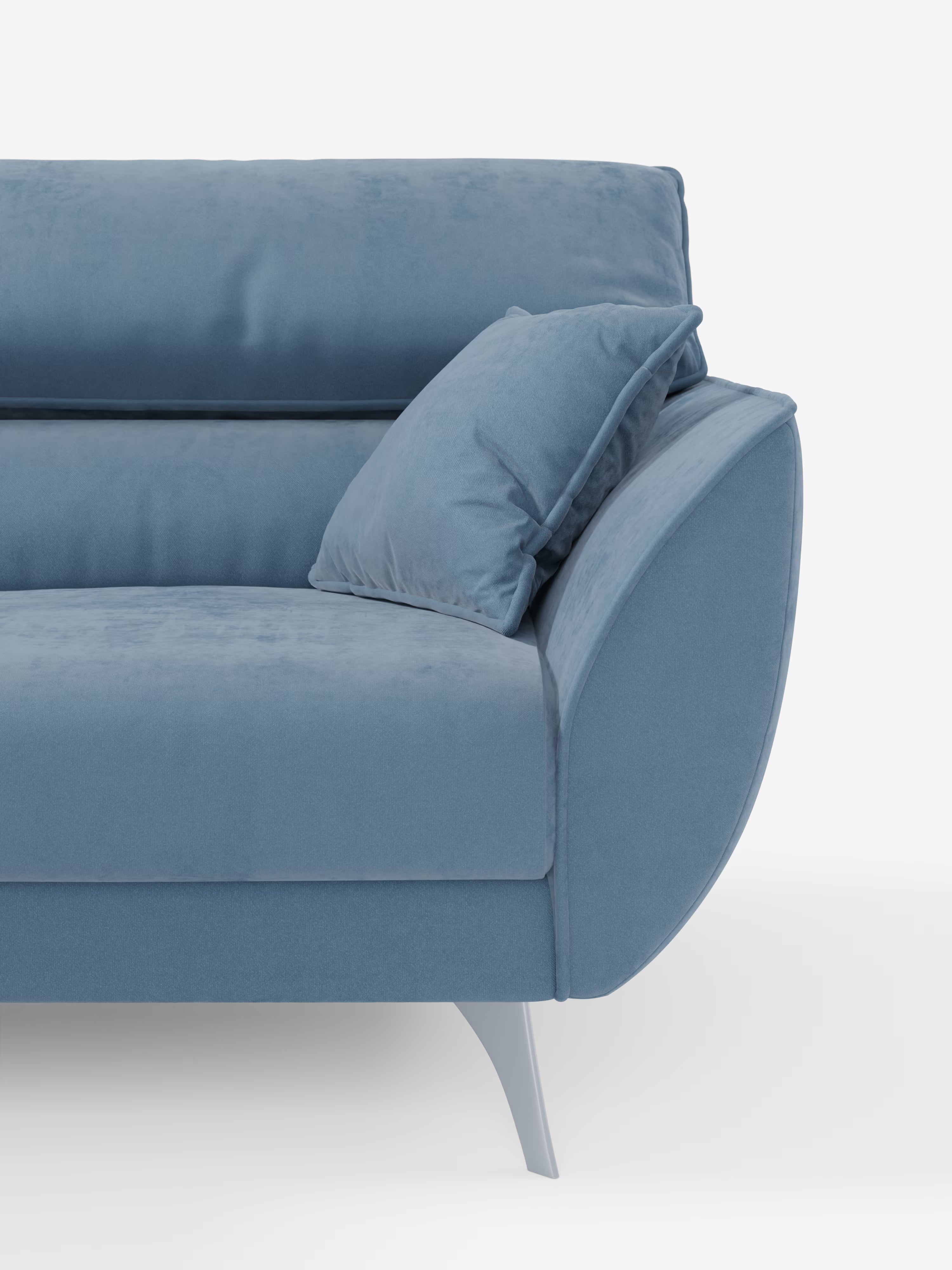 Un primo piano del divano Michelangelo a 2 e 3 posti di Divani.Store, rivestito in tessuto T30 facile da pulire. Questo moderno divano in velluto azzurro presenta braccioli curvi, gambe angolate e un cuscino blu abbinato appoggiato sul bracciolo. Su uno sfondo bianco a tinta unita, l’immagine mette in risalto la texture morbida e lo stile minimalista del divano — con sedute estensibili e poggiatesta regolabili — rendendolo una scelta intramontabile per chi è alla ricerca di un divano moderno.