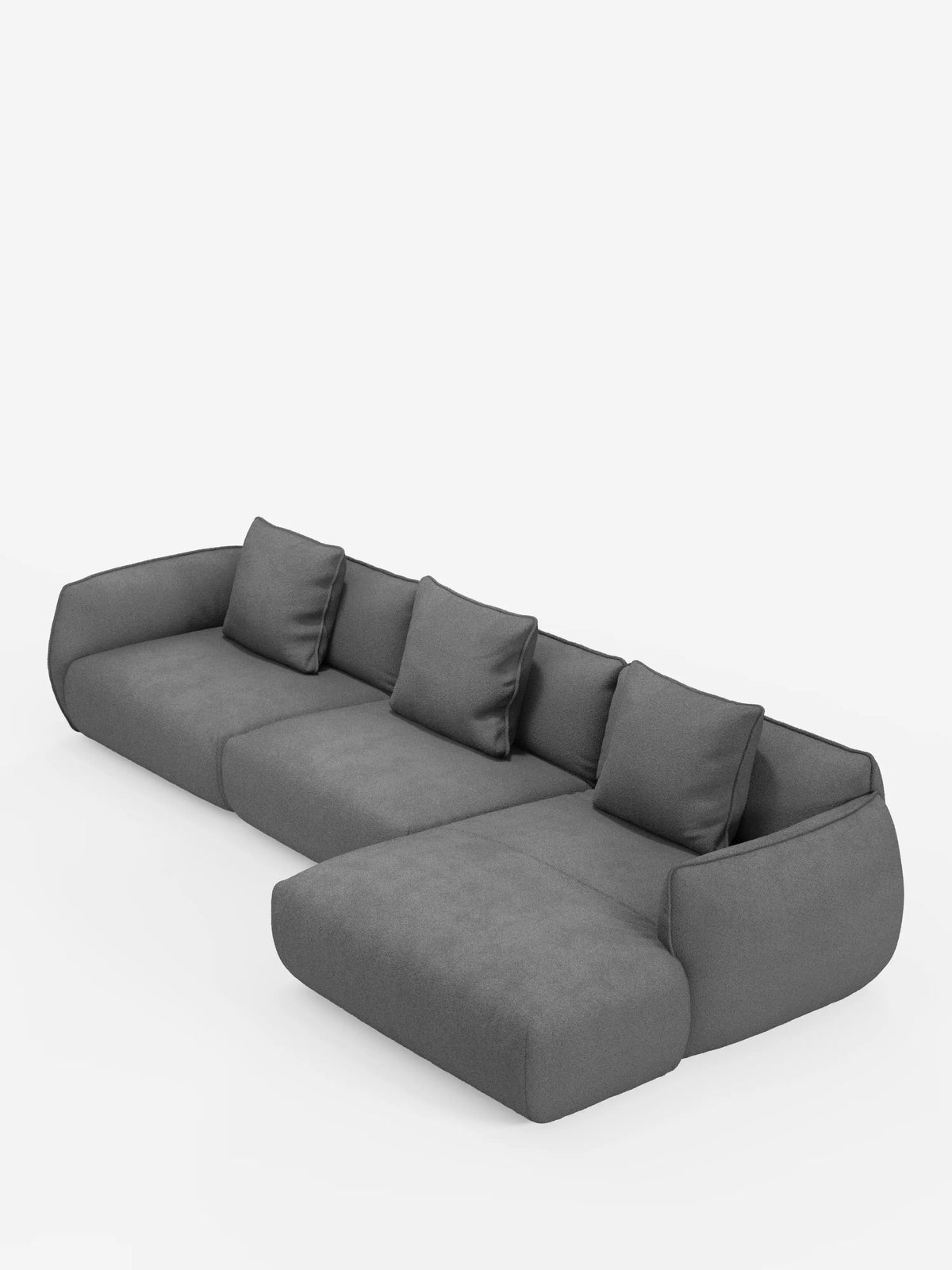 Vi presentiamo il divano angolare con penisola componibile Nimbus di Divani.Store, rivestito in un morbido tessuto T33 effetto cotone resistente alle macchie. Questo divano moderno, di colore grigio scuro, è dotato di quattro cuscini schienali e di una chaise longue allungata sul lato destro. Caratterizzato da un design morbido e arrotondato, risalta con eleganza su uno sfondo bianco a tinta unita.