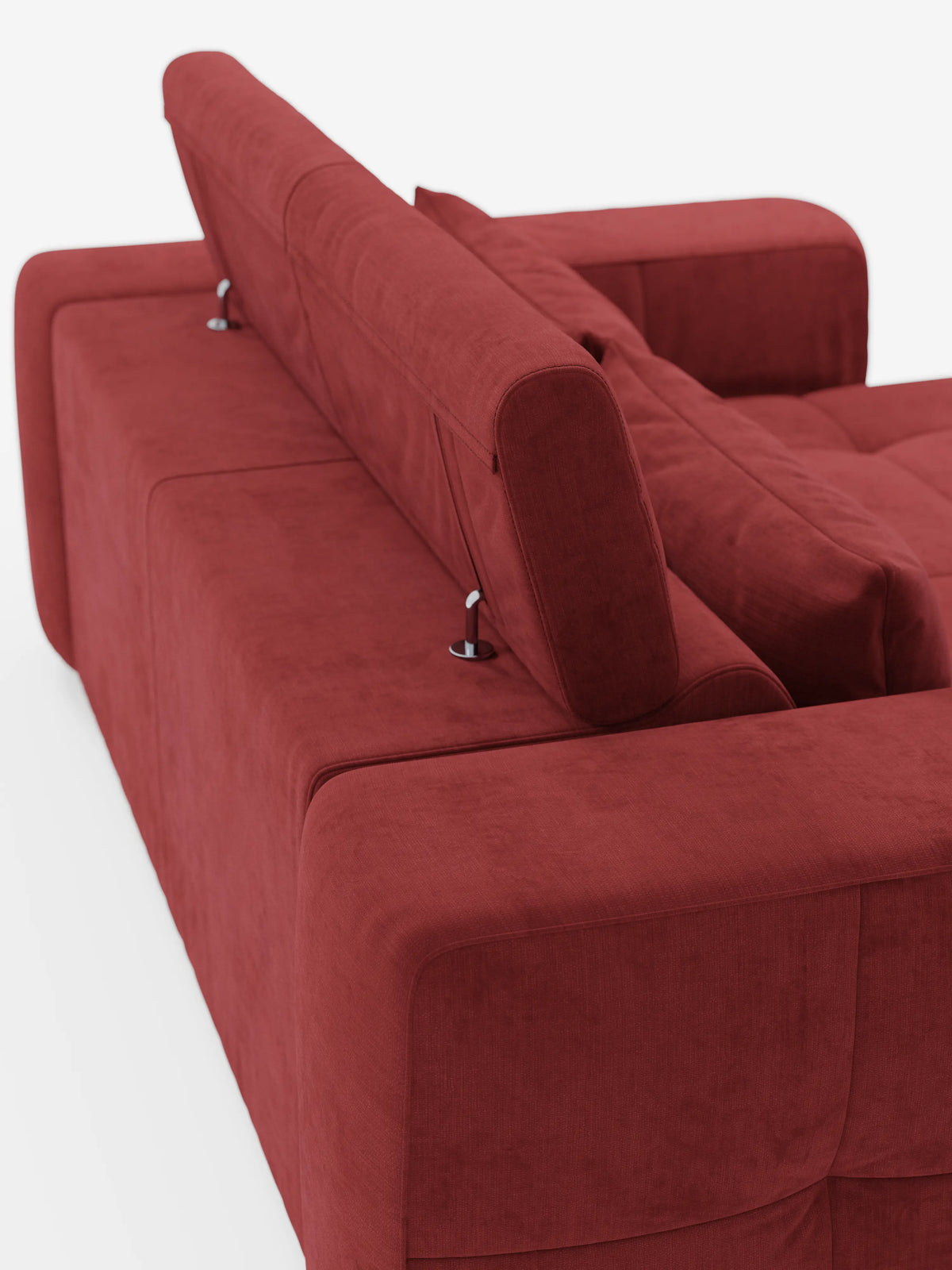 Un divano contemporaneo rosso “Monarch” con funzione relax elettrica per l’allungamento delle sedute e poggiatesta reclinabile in morbido tessuto lavabile T31 di Divani.Store è ripreso di spalle da un’angolazione obliqua. Il poggiatesta in posizione verticale, sostenuto da eleganti cerniere in metallo, e i cuscini morbidi e soffici evocano una sensazione di comfort che ricorda quella di un classico divano relax elettrico. L’ambientazione minimalista è caratterizzata da uno sfondo bianco brillante.