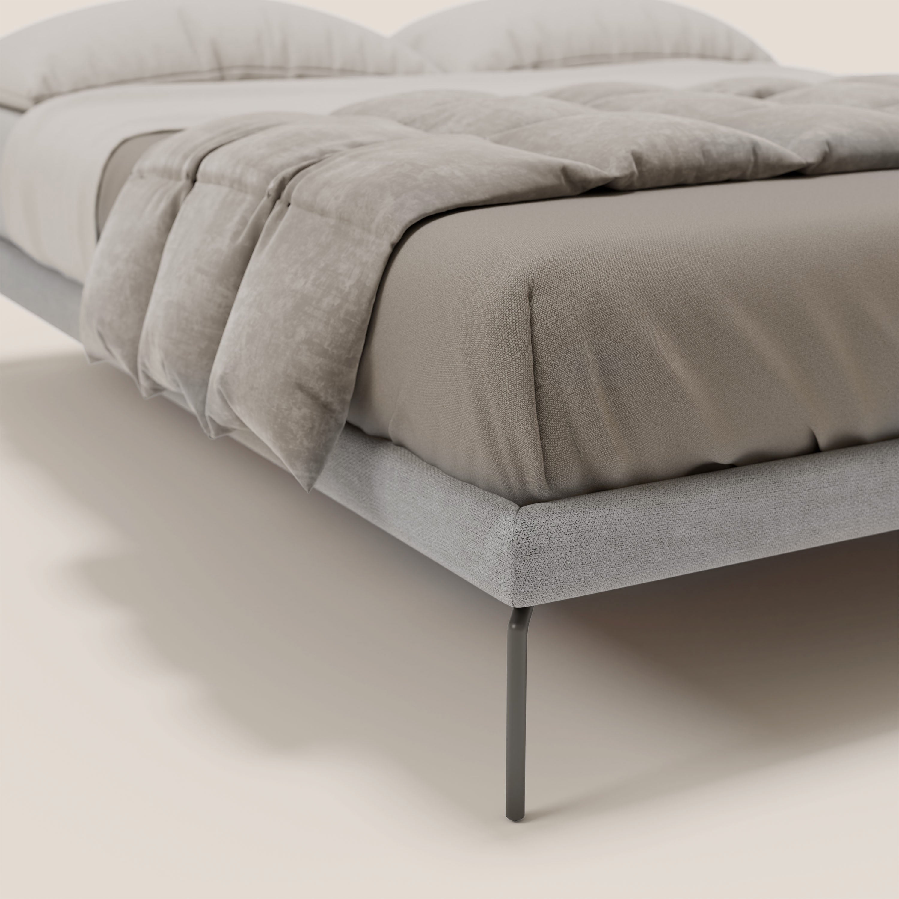 Un primo piano del sommier sfoderabile Ring di Letti.store, con gambe alte 24 cm e struttura in tessuto impermeabile T14 grigio chiaro, da abbinare alla biancheria da letto color tortora per un look accogliente e minimalista di design italiano.