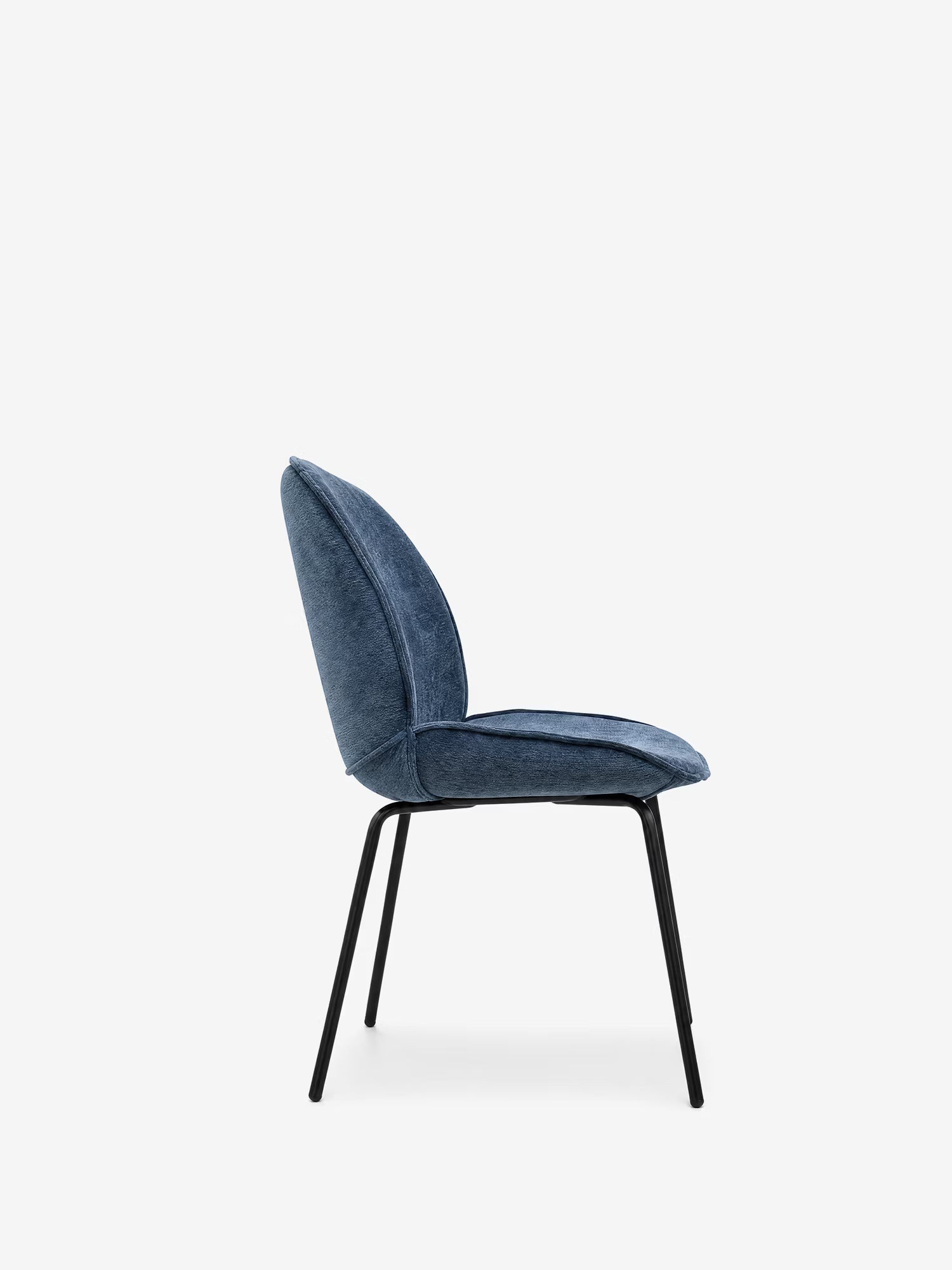 La sedia imbottita Iride di Divani.Store, raffigurata di profilo, presenta una seduta e uno schienale curvi rivestiti in tessuto blu morbido al tatto, con sottili gambe in metallo nero e un design minimalista su uno sfondo bianco a tinta unita.
