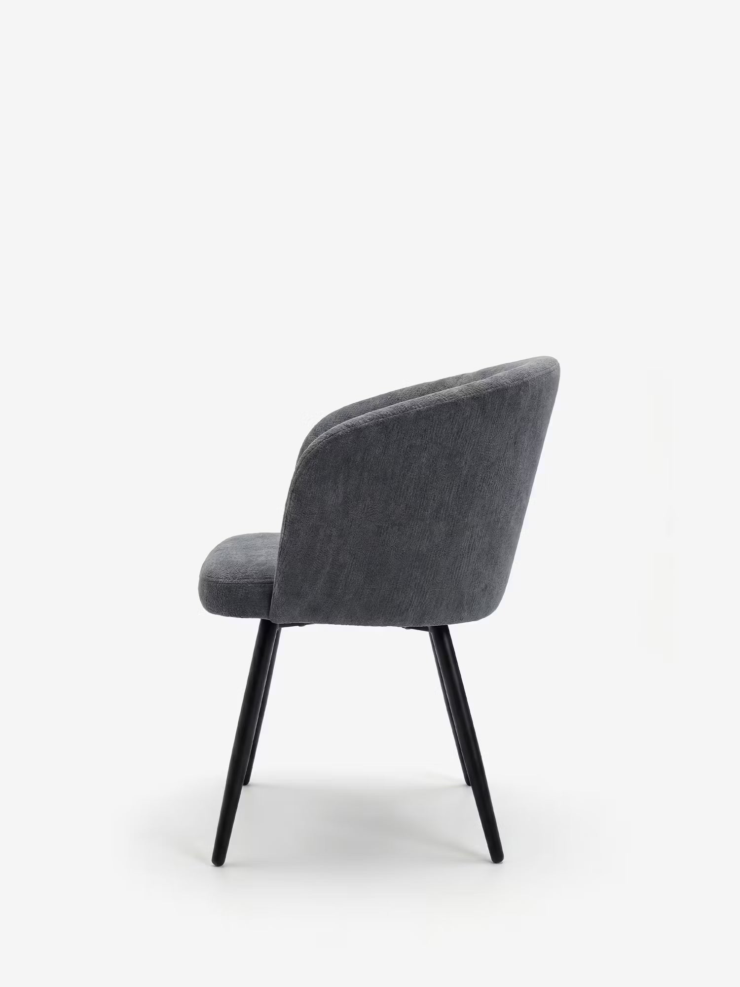 La Rovo Sedia con braccioli imbottita di Divani.Store presenta uno schienale e una seduta curvi in ciniglia grigio scuro, quattro sottili gambe in metallo nero ed è esposta su uno sfondo bianco a tinta unita con una leggera inclinazione all’indietro.