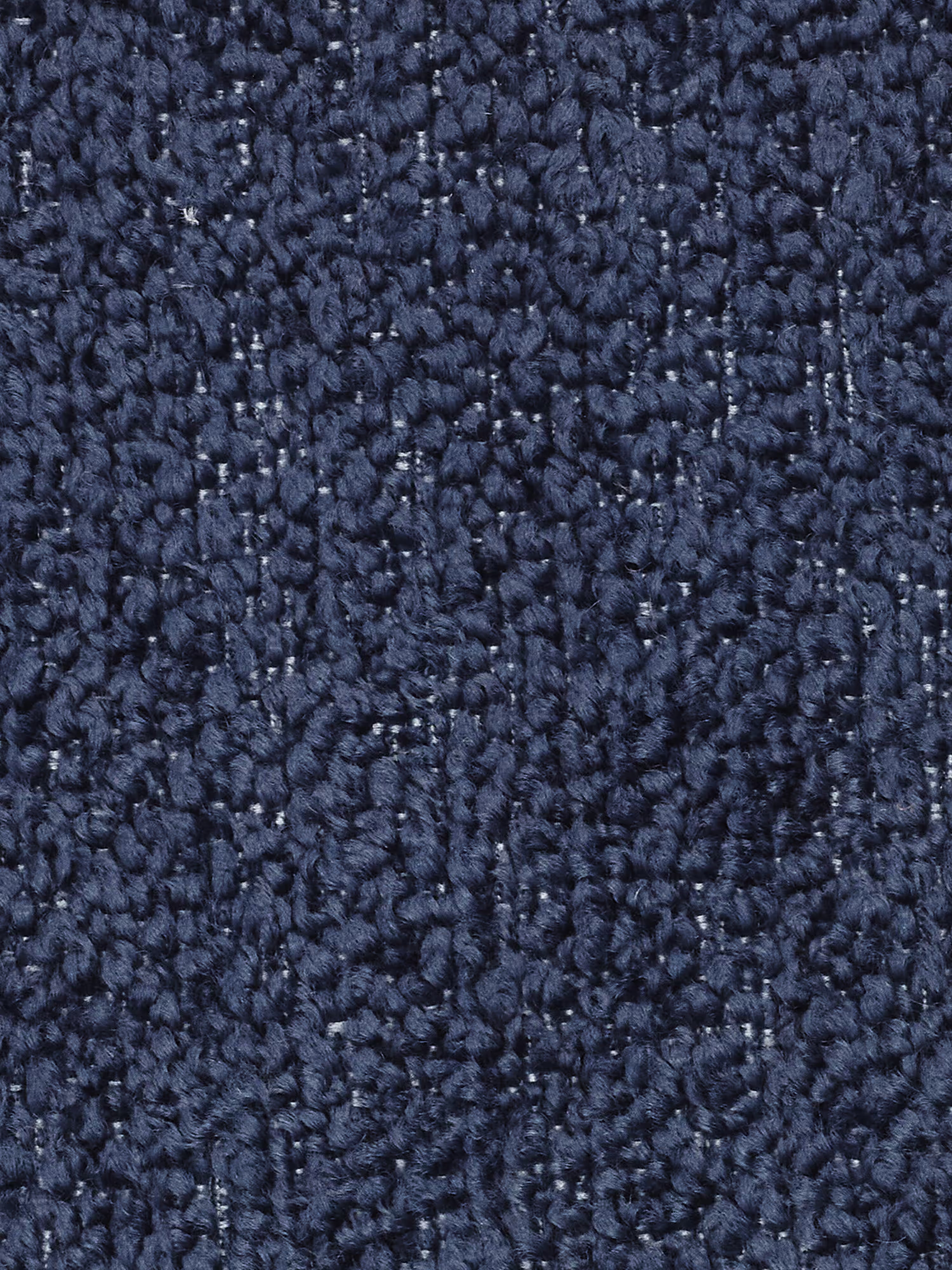Primo piano della poltrona Modulo 77 cm in bouclé capitonné, con rivestimento in tessuto T21 antimacchia di Divani.Store. Il rivestimento blu navy, dalla trama a riccioli, presenta un delicato motivo a scacchi, con filati che variano leggermente di tonalità per creare profondità e interesse visivo, richiamando i dettagli sofisticati caratteristici dei modelli di poltrone di alta gamma. Il materiale appare morbido ma resistente, ideale per eleganti ambienti abitativi o uffici.
