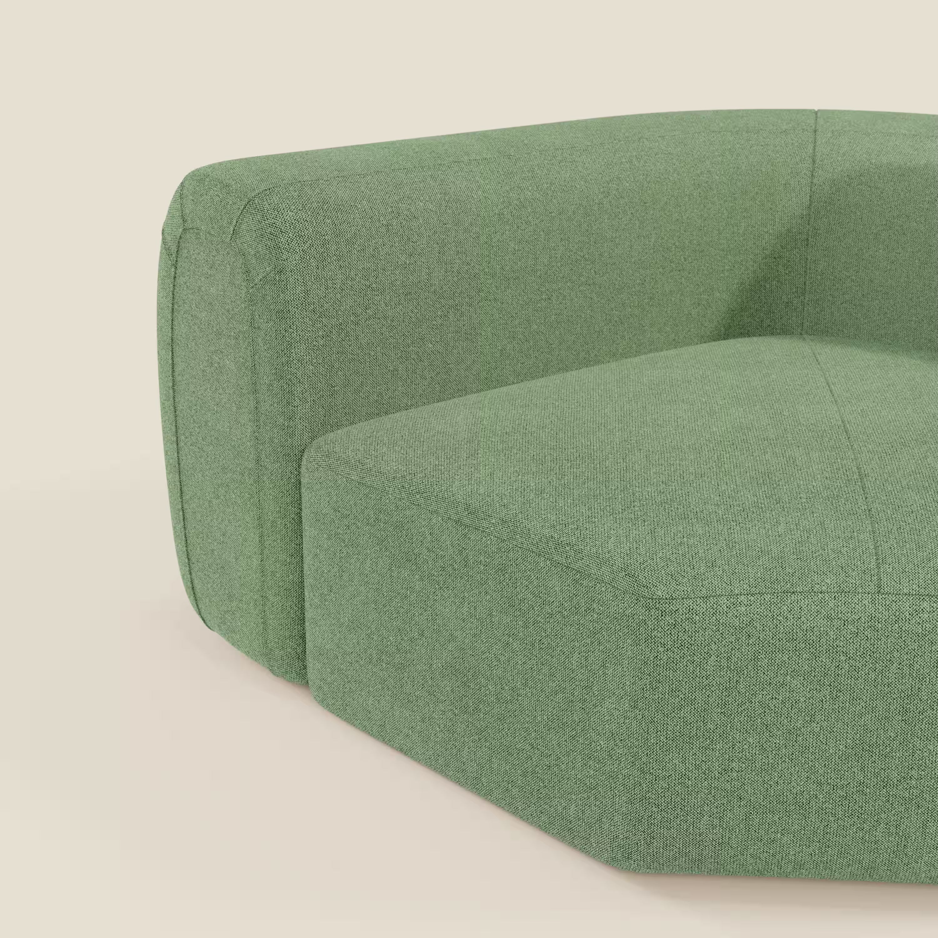 Un primo piano di Bonbon Modulo angolare di Divani.Store, un moderno divano componibile in tessuto antimacchia T23 color menta, che mostra la seduta profonda, il bracciolo basso e la morbida imbottitura su uno sfondo crema chiaro.