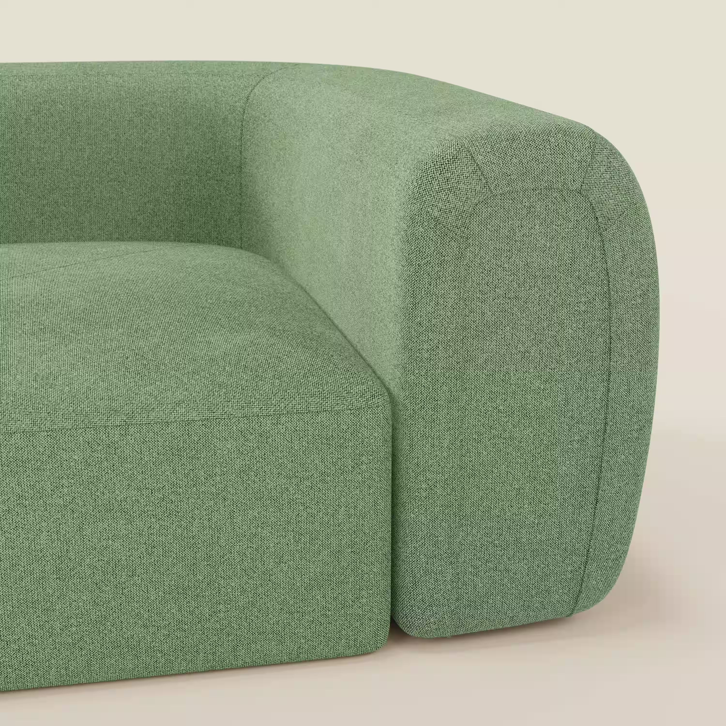 Primo piano del Bonbon Modulo angolare di Divani.Store, un moderno divano componibile in tessuto antimacchia T23 menta, che mette in evidenza lo spesso bracciolo arrotondato e il cuscino di seduta su uno sfondo beige neutro.