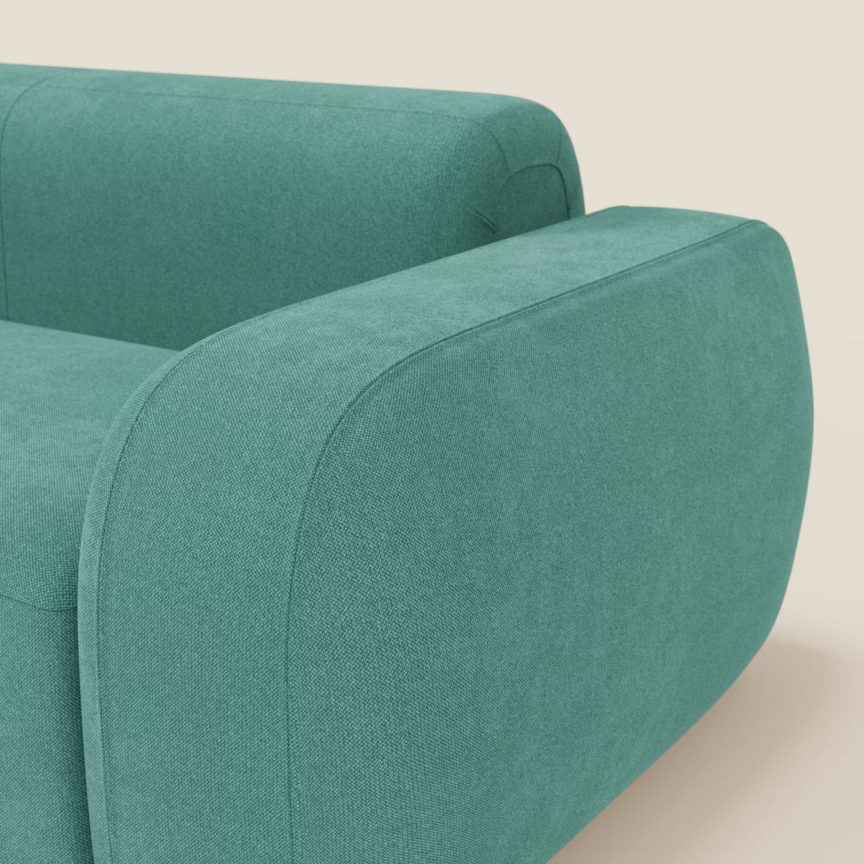 Primo piano del BonBon Divano modulare Lineare 220 di Divani.Store: un moderno divano compatto verde acqua dai bordi arrotondati, dal design minimalista e raffinato, con una seduta singola in morbido tessuto T23 facile da pulire su uno sfondo beige chiaro.