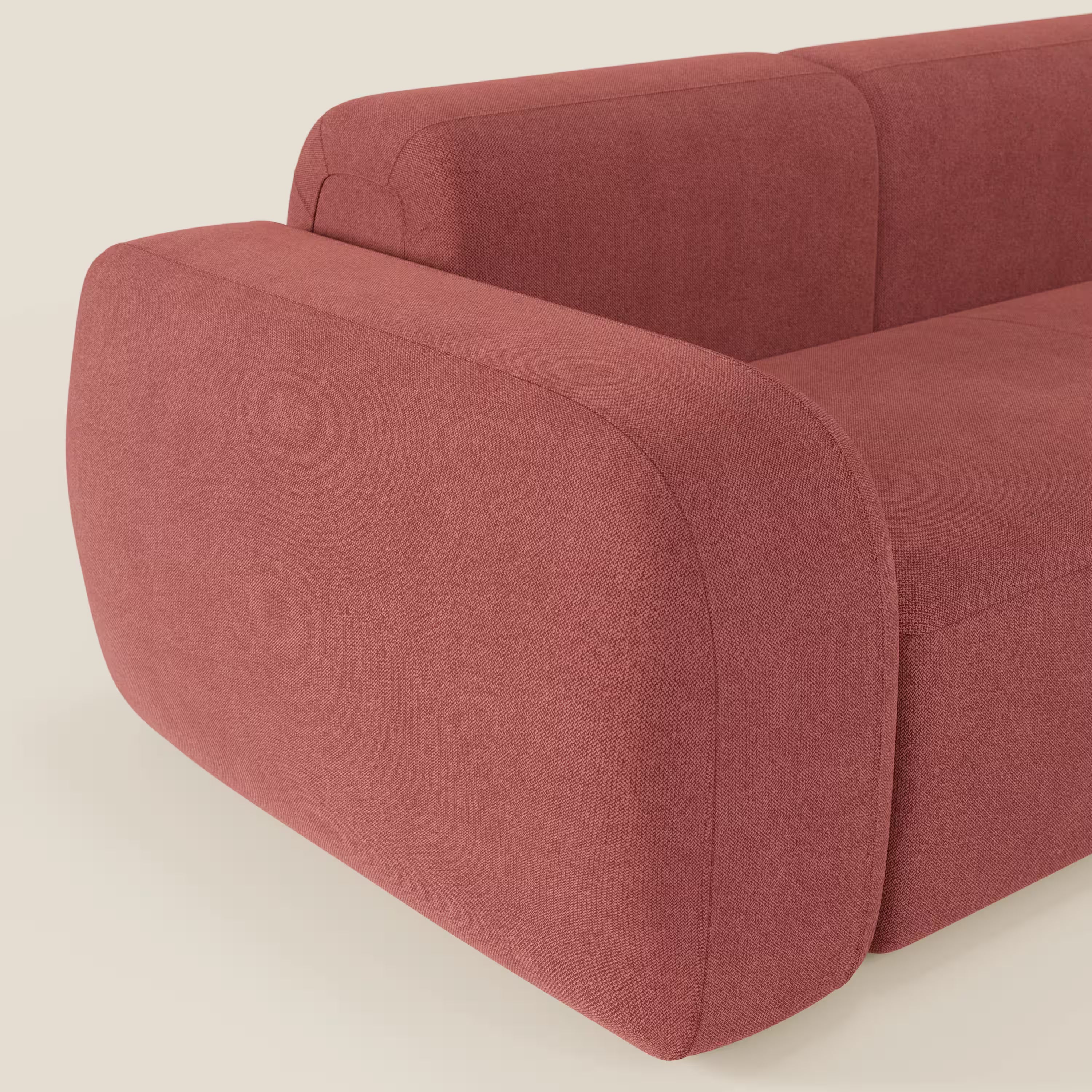 Una vista ravvicinata di BonBon Divano componibile - Composizione Spaccamattone di Divani.Store, caratterizzato da bordi arrotondati, braccioli spessi e tessuto smacchiabile T23 rosso ciliegia in un design minimalista e contemporaneo.