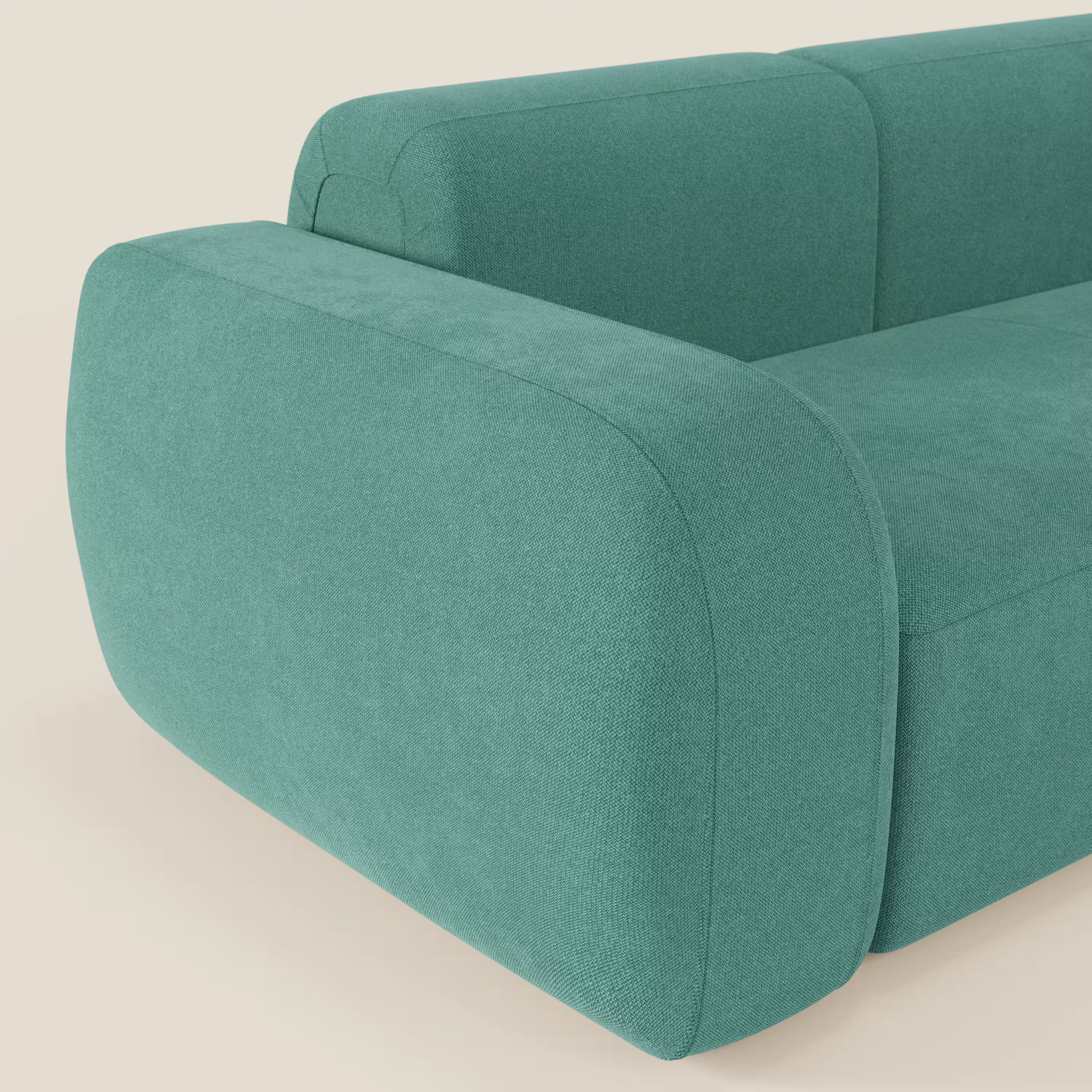 Primo piano del BonBon Divano componibile - Composizione Spaccamattone di Divani.Store, caratterizzato da braccioli e schienale spessi e arrotondati in tessuto smacchiabile T23 verde acqua, con curve morbide e stile minimalista su sfondo bianco sporco.