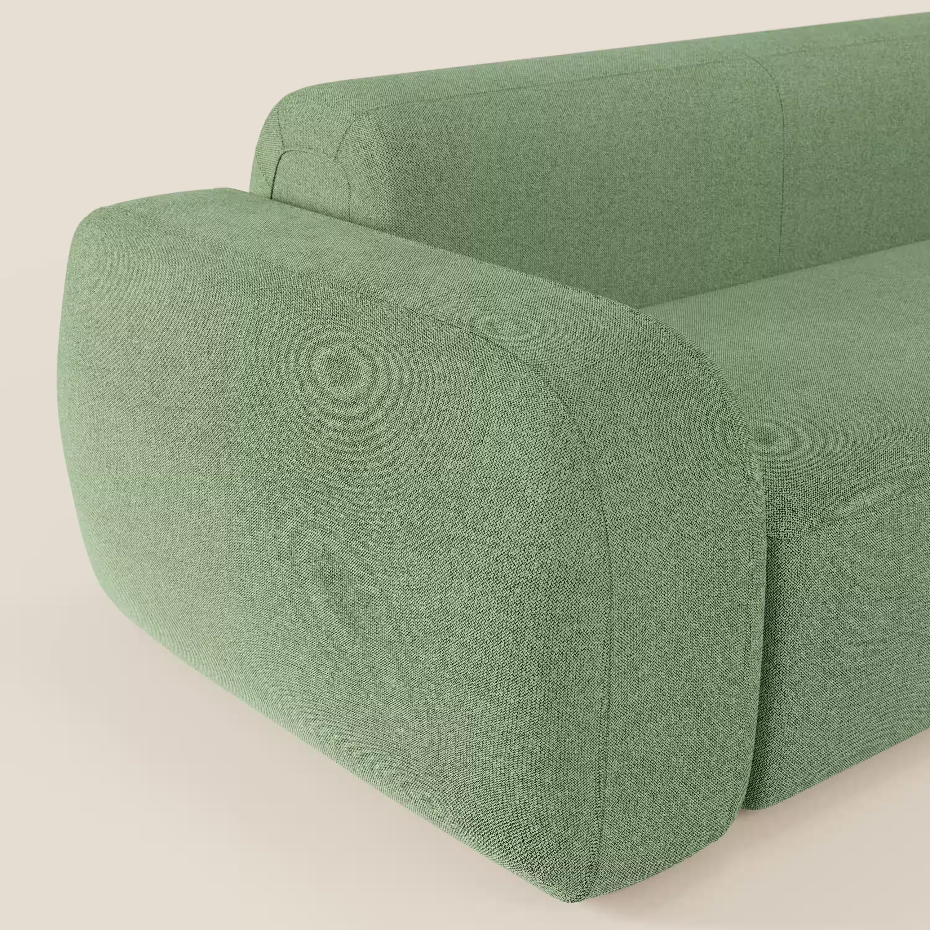 Un primo piano del divano angolare componibile e modulare BonBon di Divani.Store in tessuto smacchiabile T23 menta mette in evidenza il bracciolo e lo schienale spessi e arrotondati, il rivestimento liscio e il design minimalista e contemporaneo su misura.