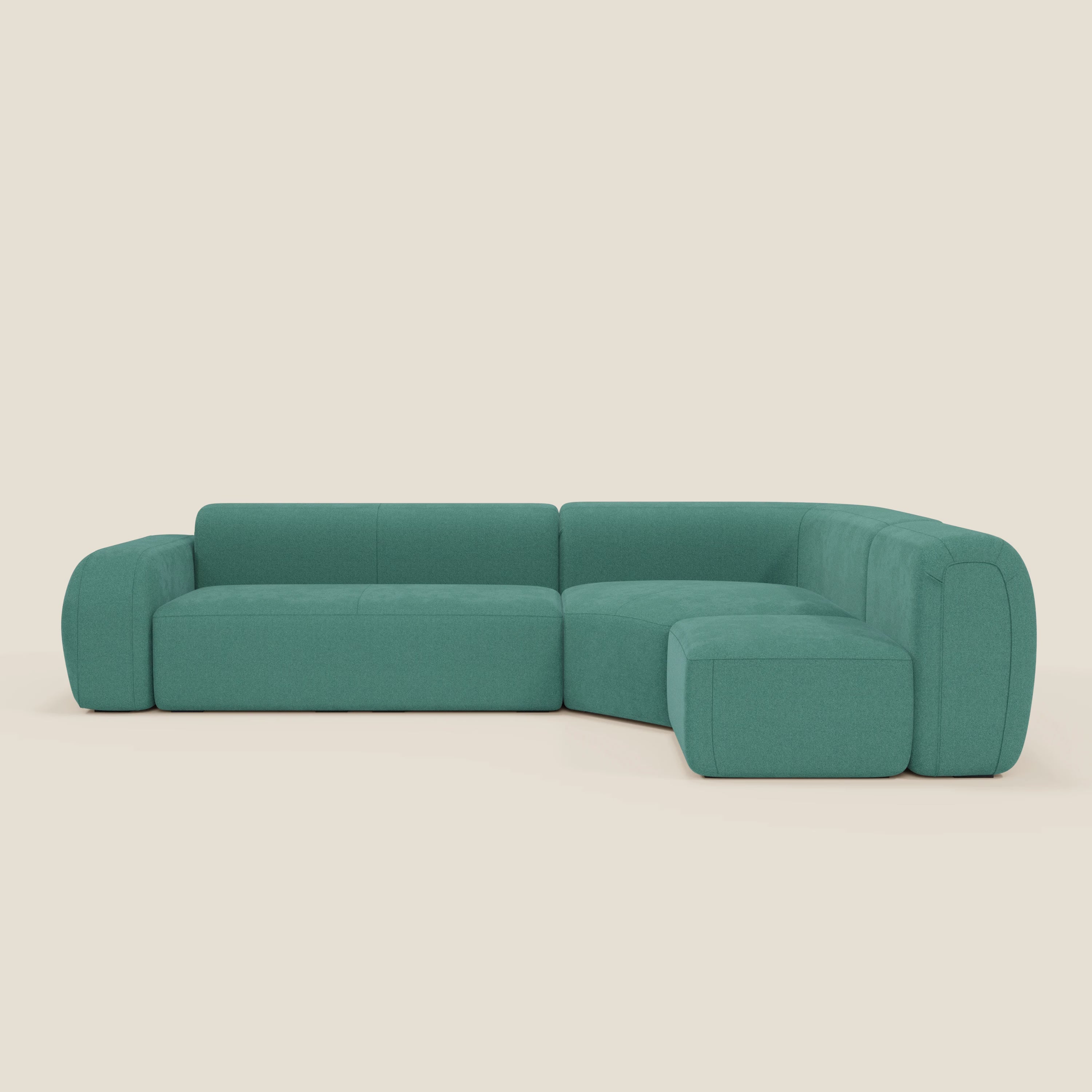 Il divano BonBon angolare componibile e modulare di Divani.Store in smacchiabile T23 verde acqua presenta braccioli spessi e arrotondati, schienali bassi e sedute imbottite per uno stile minimalista su uno sfondo beige chiaro.