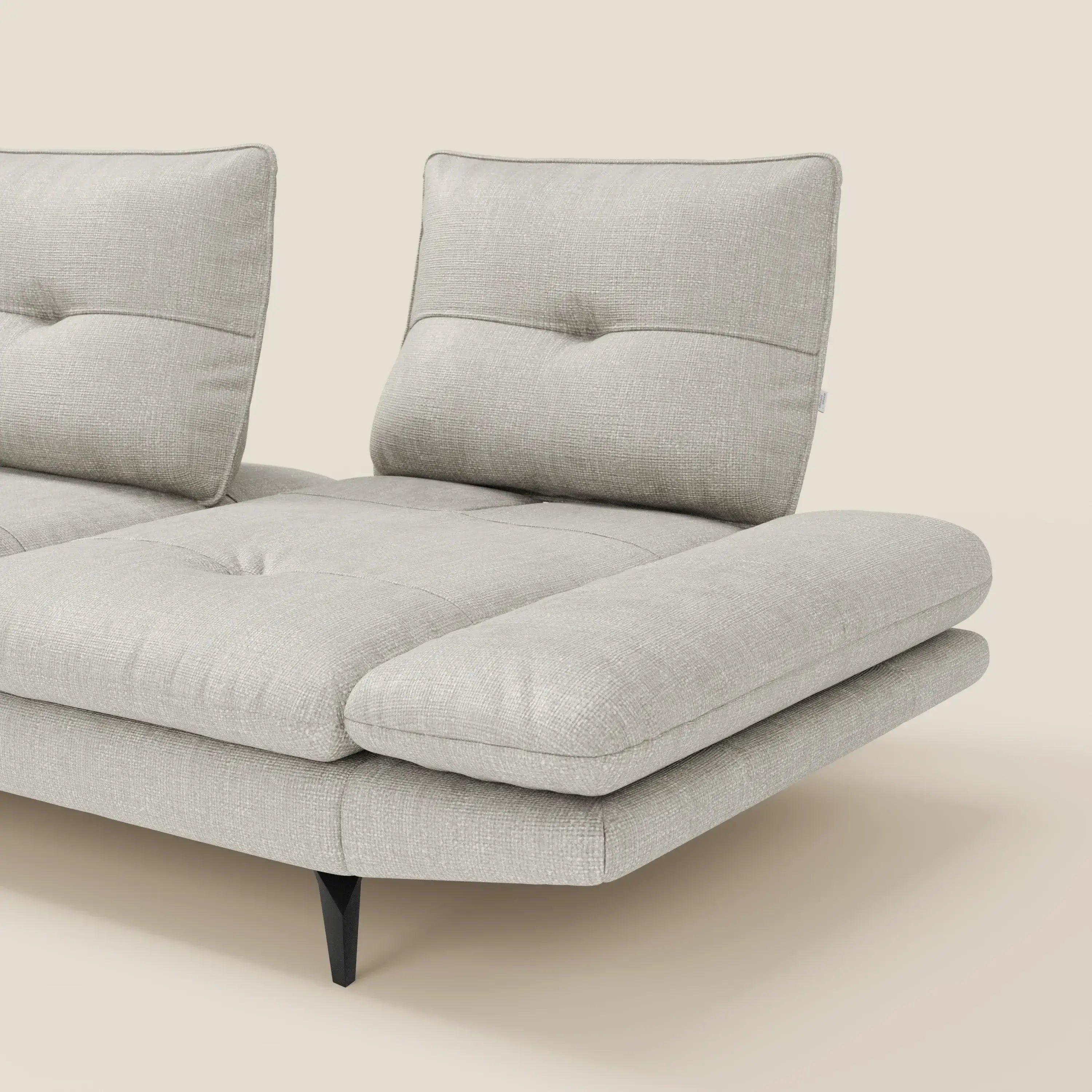 Il Divano con penisola Ardex di Divani.Store è caratterizzato da schienali traslanti, braccioli regolabili e dall'elegante tessuto impermeabile T06 di colore grigio chiaro, con linee pulite ed eleganti gambe nere.