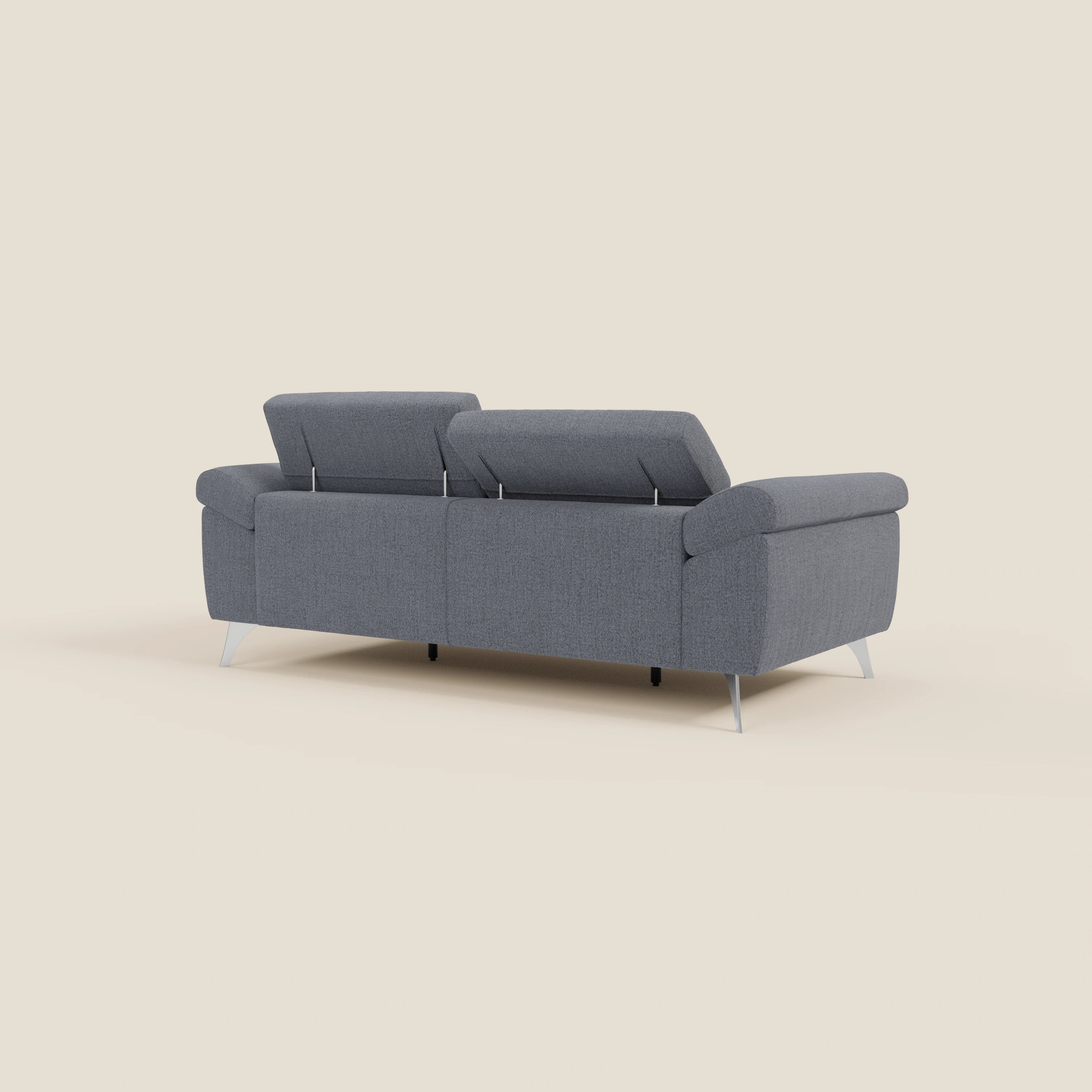 Il divano Donatello con sedute allungabili, braccioli contenitore e poggiatesta reclinabili in tessuto smacchiabile T23 blu grafite di Divani.Store è mostrato da dietro su sfondo beige chiaro, evidenziando comfort intelligente e design contemporaneo.