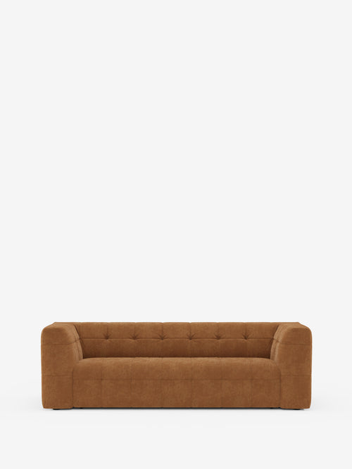 Un divano modulare contemporaneo di Divani.Store, il Mosaic Divano a 3 e 4 posti presenta un profilo minimalista e squadrato, senza gambe a vista. Rivestito in tessuto bouclé T21 antimacchia e caratterizzato da cuscini quadrati trapuntati (capitonné) e braccioli spessi, questo elemento d’arredo moderno è presentato su uno sfondo bianco a tinta unita per un look elegante e lineare.