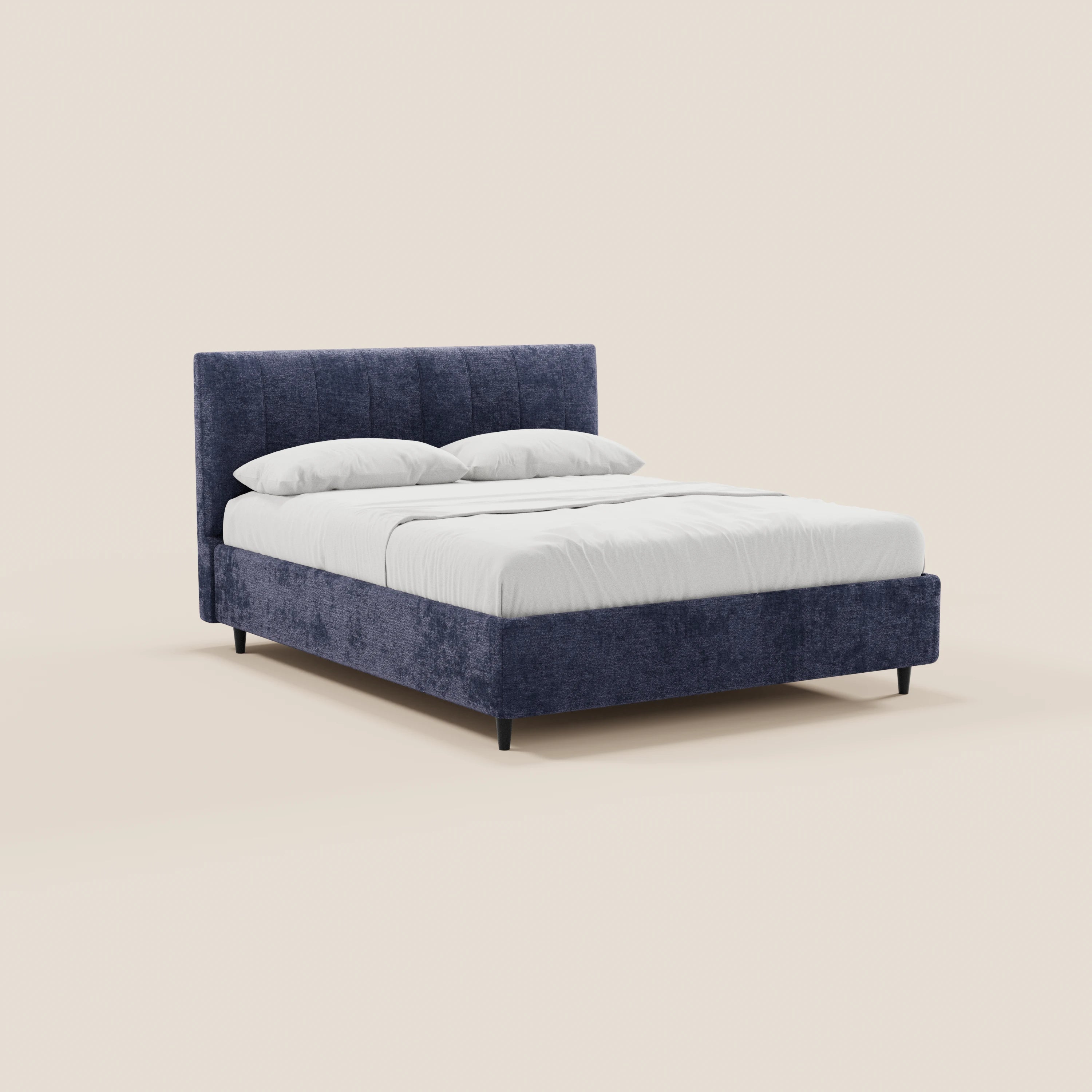 Il letto imbottito ONYX con contenitore di Letti.store presenta una struttura in tessuto blu scuro certificato Oeko-Tex® e una testiera verticale su quattro gambe nere, abbinato a biancheria da letto bianca e due cuscini su uno sfondo beige chiaro.