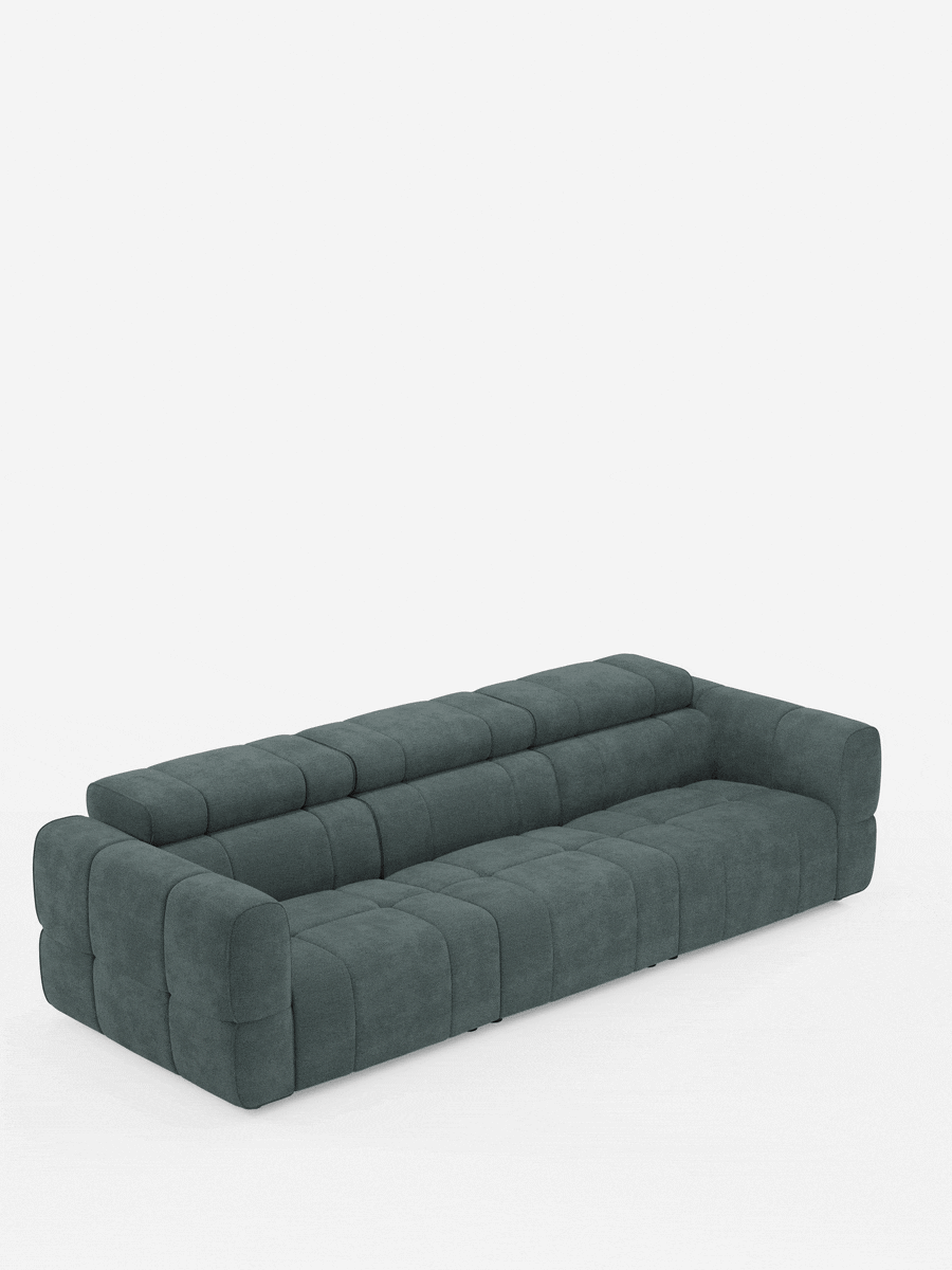 Un divano modulare Giotto grigio scuro a 4 posti con poggiatesta reclinabili e funzione relax elettrica opzionale, rivestito in tessuto smacchiabile T23, dal design trapuntato, con ampi braccioli e poggiatesta regolabili, è raffigurato su uno sfondo bianco.