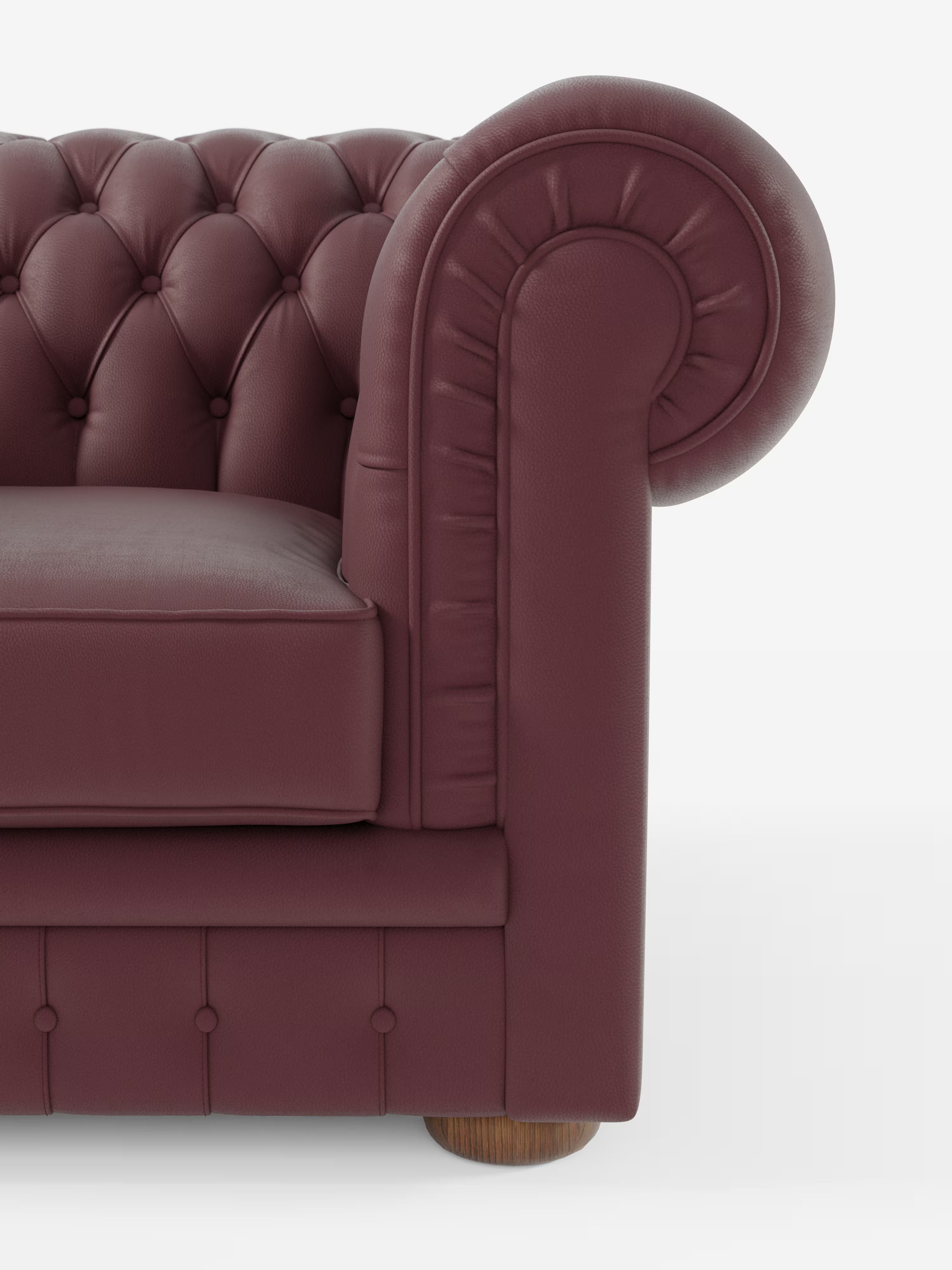 Primo piano della poltrona Chester in vera pelle spessorata con capitonné artigianale di Divani.Store, che mette in risalto il suo ricco rivestimento in vera pelle marrone scuro trapuntata, il bracciolo elegantemente ricurvo con dettagli plissettati e il classico piedino a pallina in legno. Il morbido cuscino e il design intramontabile evocano un senso di lusso e tradizione, mentre la meticolosa lavorazione artigianale è evidente in ogni dettaglio. Immagine su sfondo bianco.