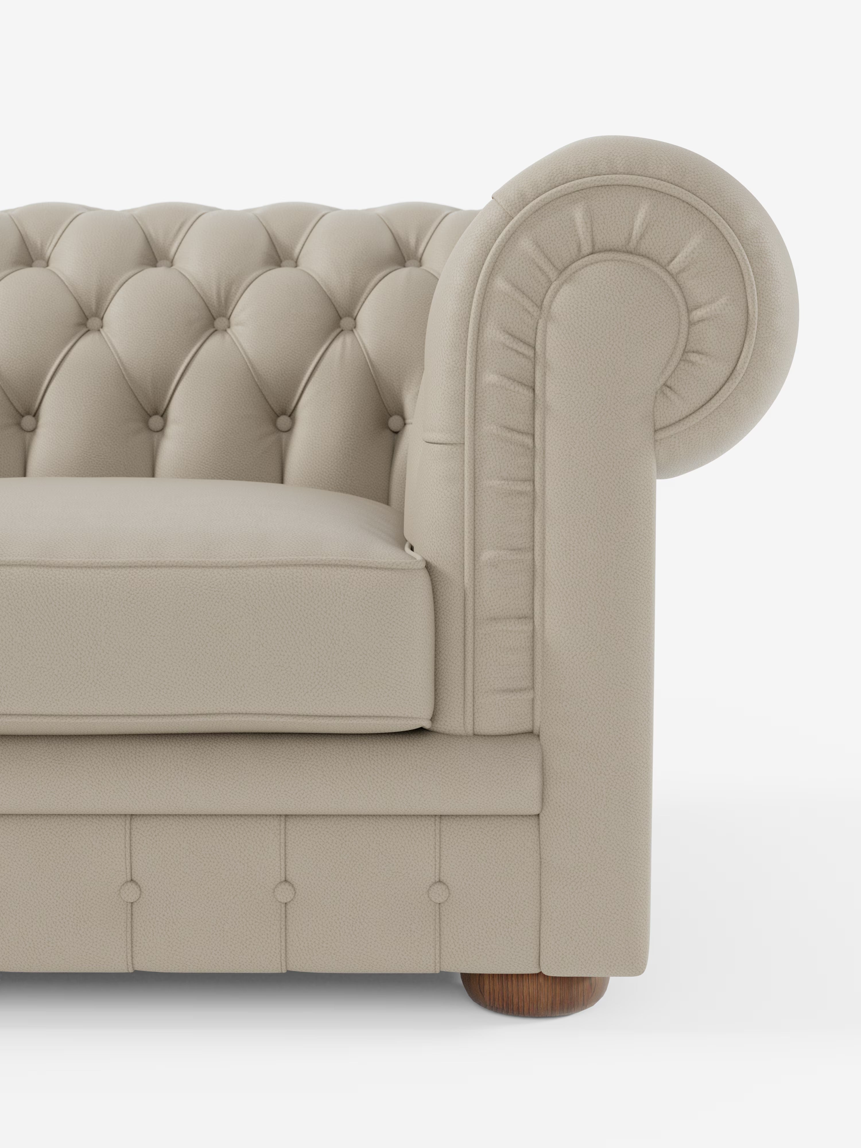 Su uno sfondo bianco, è visibile solo la metà destra dell’elegante Chester – Divano Chesterfield in vera pelle spessorata a 2 e 3 posti di Divani.Store. Questo divano in pelle beige trapuntata presenta braccioli arrotondati, intricati dettagli a bottoni sia sullo schienale che sulla base e una gamba in legno nell’angolo in basso a destra, a testimonianza di una lavorazione artigianale di lusso ispirata ai classici modelli Chesterfield.
