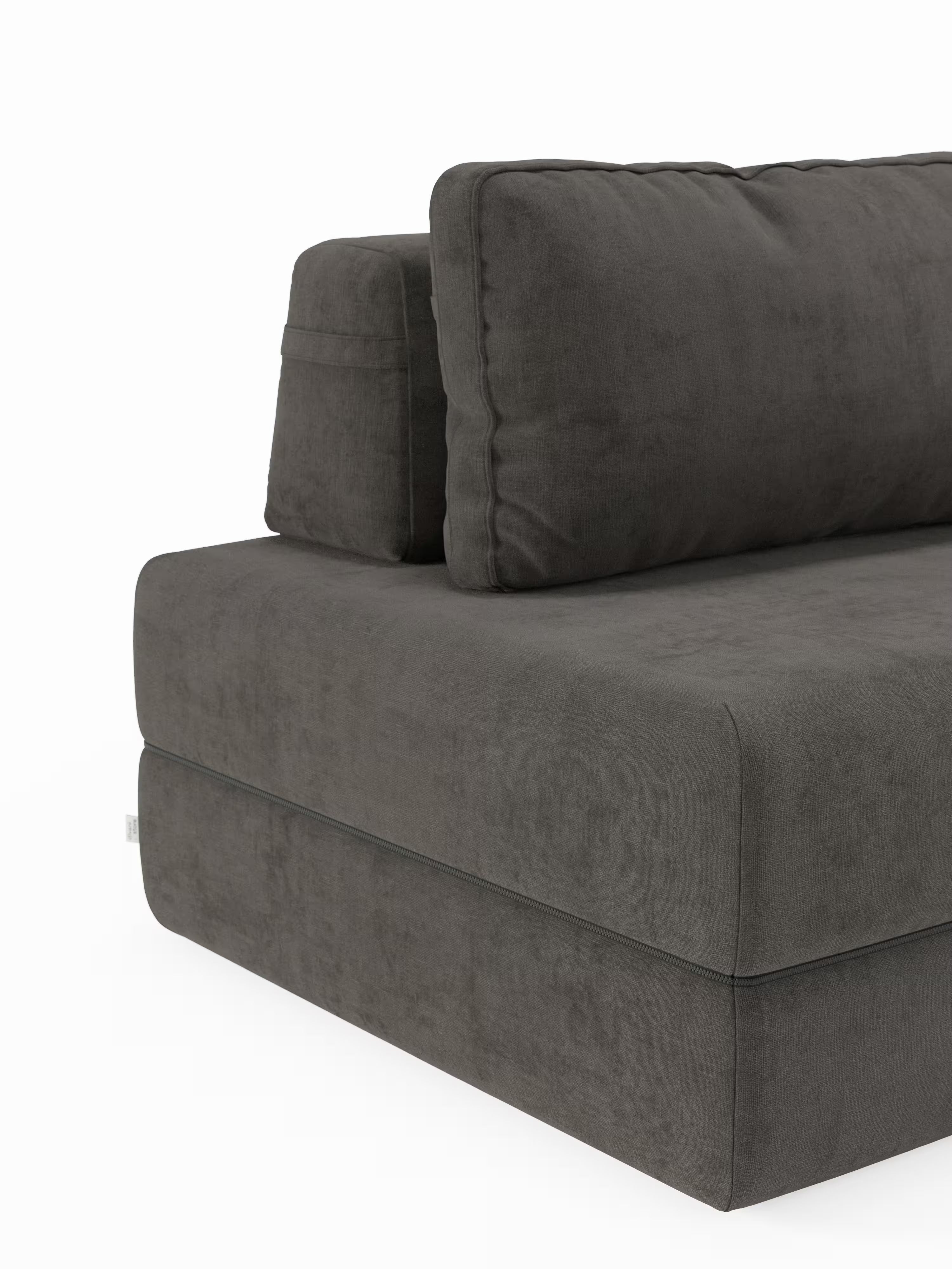 Un primo piano della poltrona letto Rift con materasso alto 22 cm e memory foam di Divani.Store, rivestita in tessuto T31 grigio scuro resistente alle macchie. L’immagine mette in risalto lo schienale mobile e i cuscini quadrati della seduta e dello schienale, esaltando l’elegante design della poltrona trasformabile su uno sfondo bianco. La seduta angolare a vista, il bracciolo e lo schienale sottolineano la sua combinazione di comfort e stile contemporaneo.