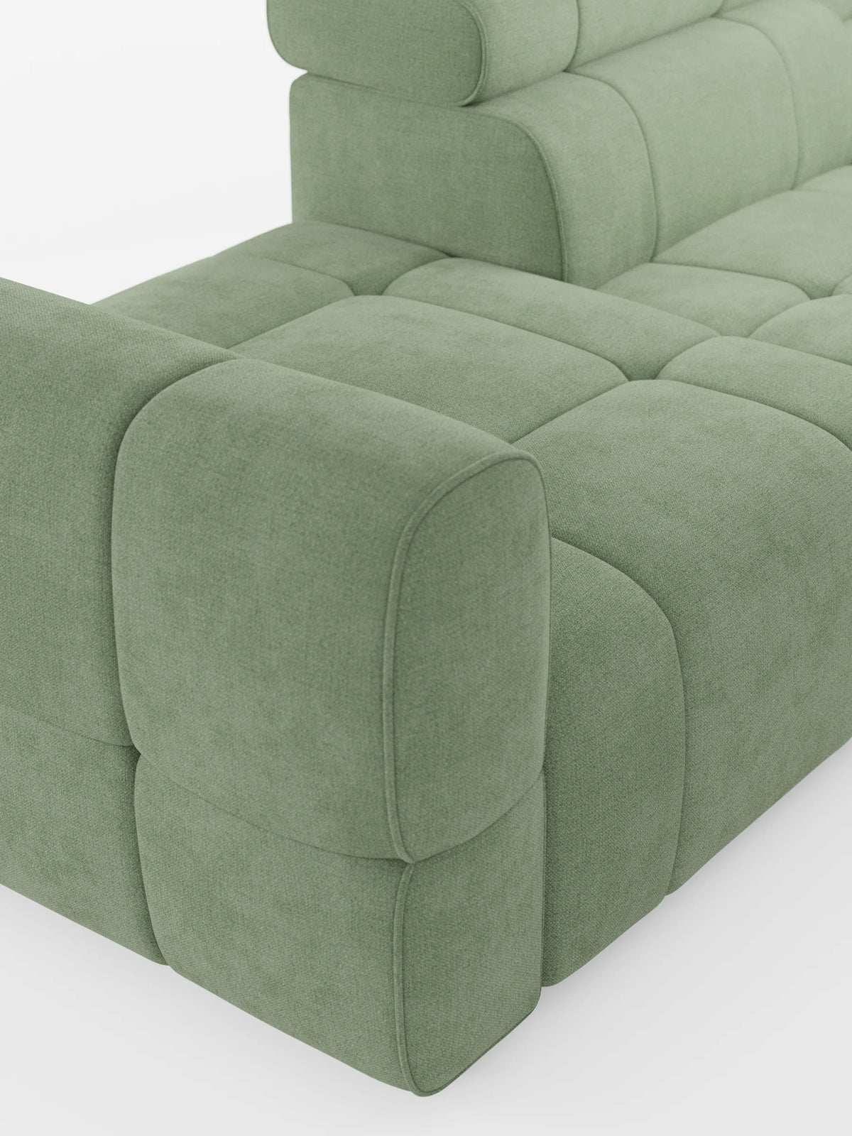 Un divano componibile Giotto Divano color verde salvia con terminale aperto - opzione relax elettrico in tessuto smacchiabile T23: divano modulare con texture trapuntata, cuscini arrotondati e sezione terminale aperta su sfondo bianco.