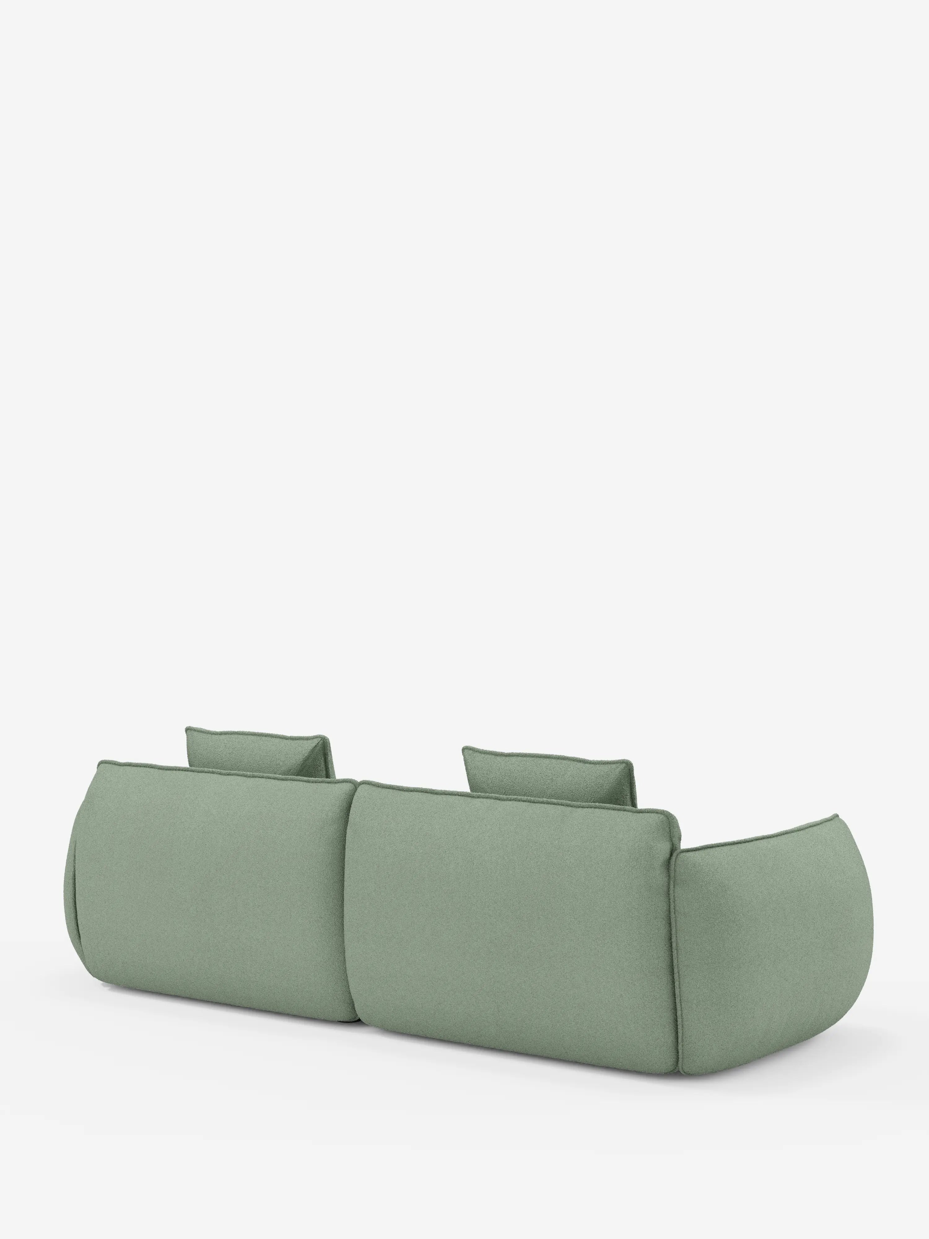 Il divano Nimbus, un modello moderno e minimalista a 3 posti, modulare e componibile da 250 cm di Divani.Store, è rivestito in tessuto effetto cotone resistente alle macchie color verde salvia (t33) e presenta due cuscini dello schienale. Visto da dietro su uno sfondo bianco a tinta unita, questo divano mette in risalto la sua forma morbida e arrotondata, senza gambe visibili, per un look elegante e basso rispetto al pavimento.