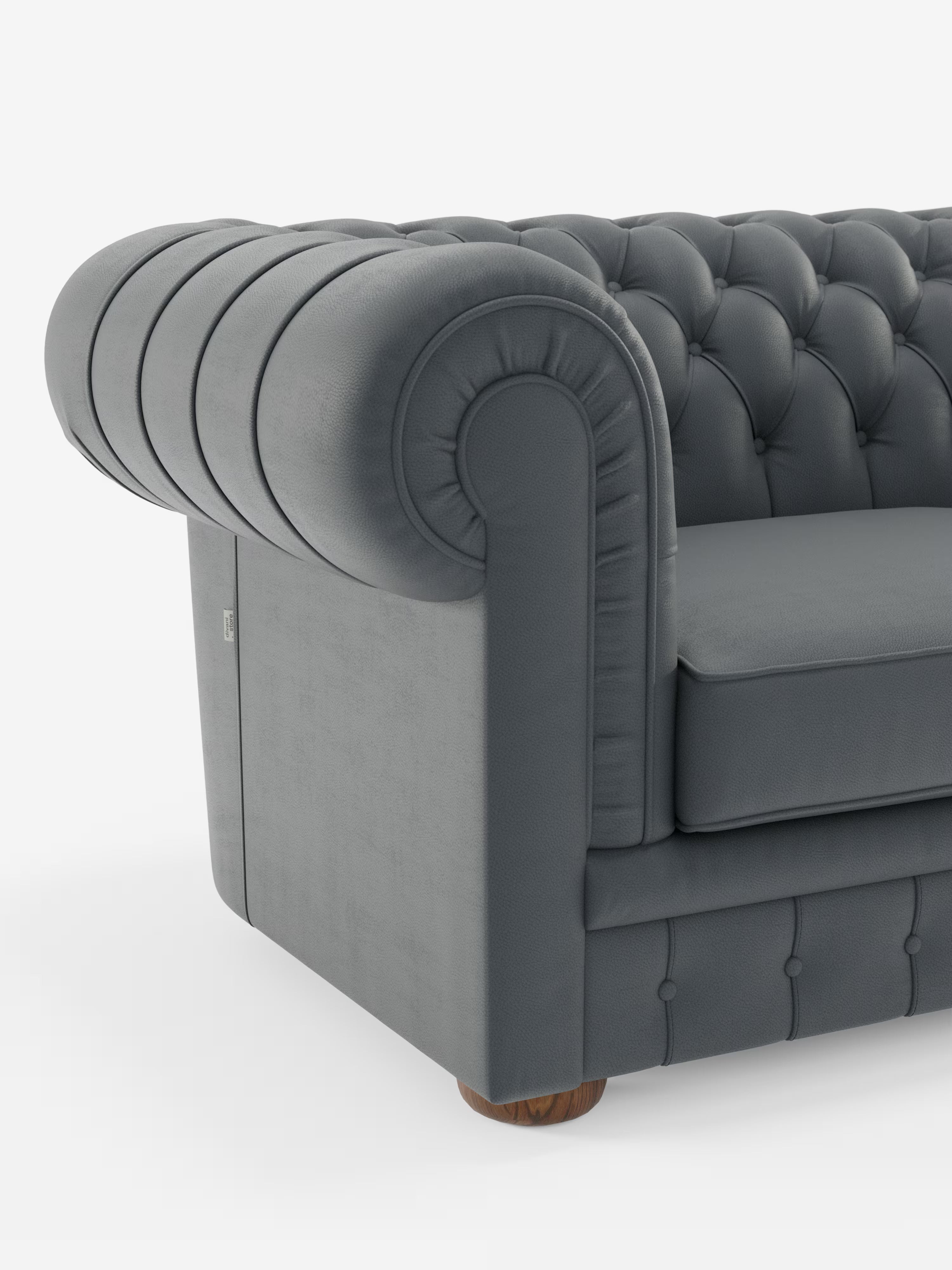 Vista parziale del Chester – Divano Chesterfield in vera pelle spessorata a 2 e 3 posti di Divani.Store, caratterizzato da schienale e braccioli con profonda trapuntatura a bottoni, classici braccioli arrotondati, cuscino di seduta liscio e piccoli piedini in legno. Il lussuoso rivestimento del divano è realizzato in vera pelle spessorata. Questo elegante modello incarna il fascino intramontabile di un divano artigianale di produzione italiana. Lo sfondo è bianco a tinta unita.