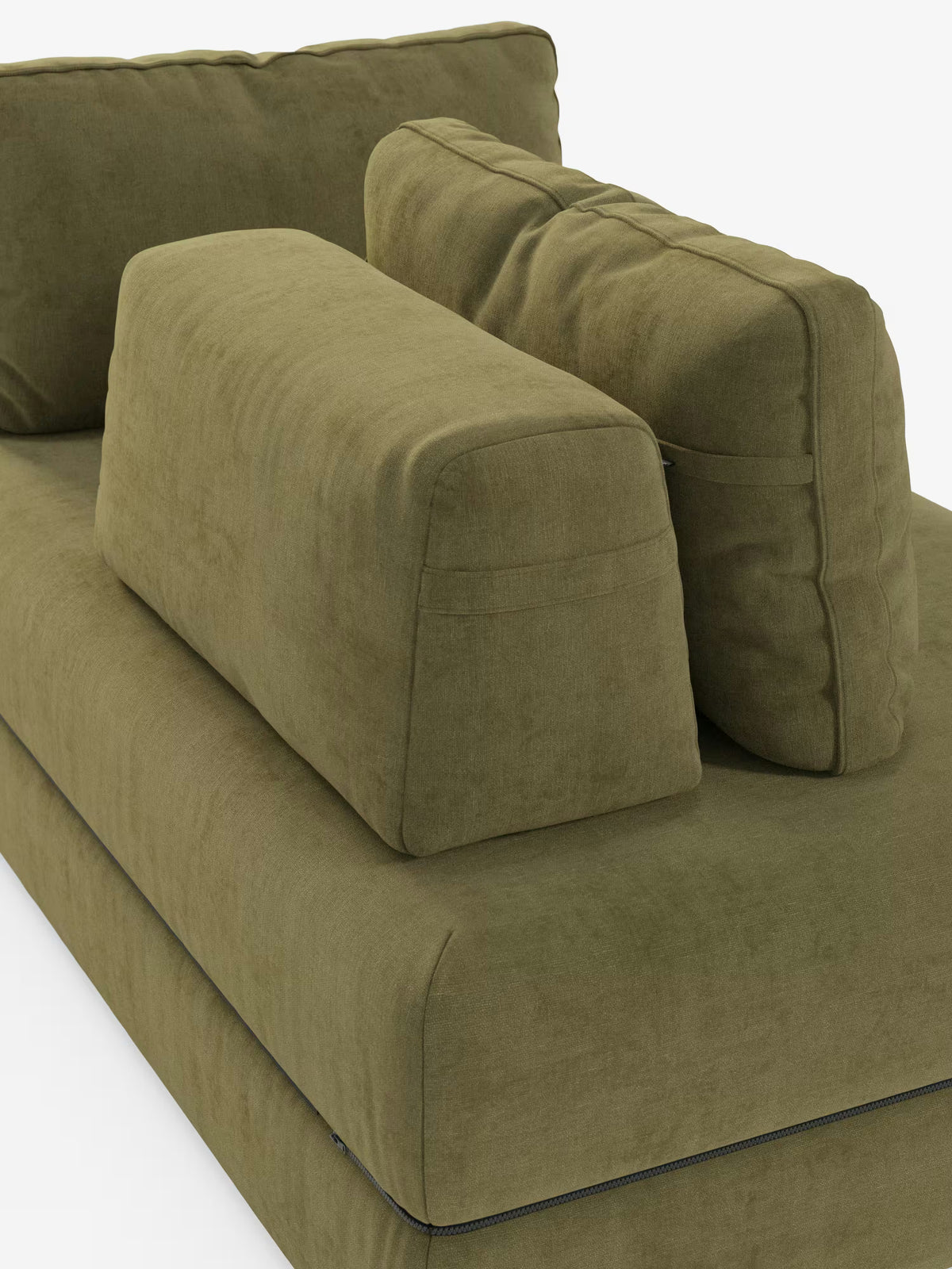 Un primo piano del divano letto matrimoniale Rift a 2 e 3 posti con schienali mobili di Divani.Store, nella moderna finitura verde oliva, mette in risalto i suoi morbidi cuscini di seduta e schienale dalla trama ricca, accompagnati da un grande cuscino rettangolare e da uno più piccolo a forma di cuneo disposti sulla seduta. Il rivestimento in tessuto smacchiabile T31 presenta cuciture a vista, il tutto su uno sfondo bianco a tinta unita.