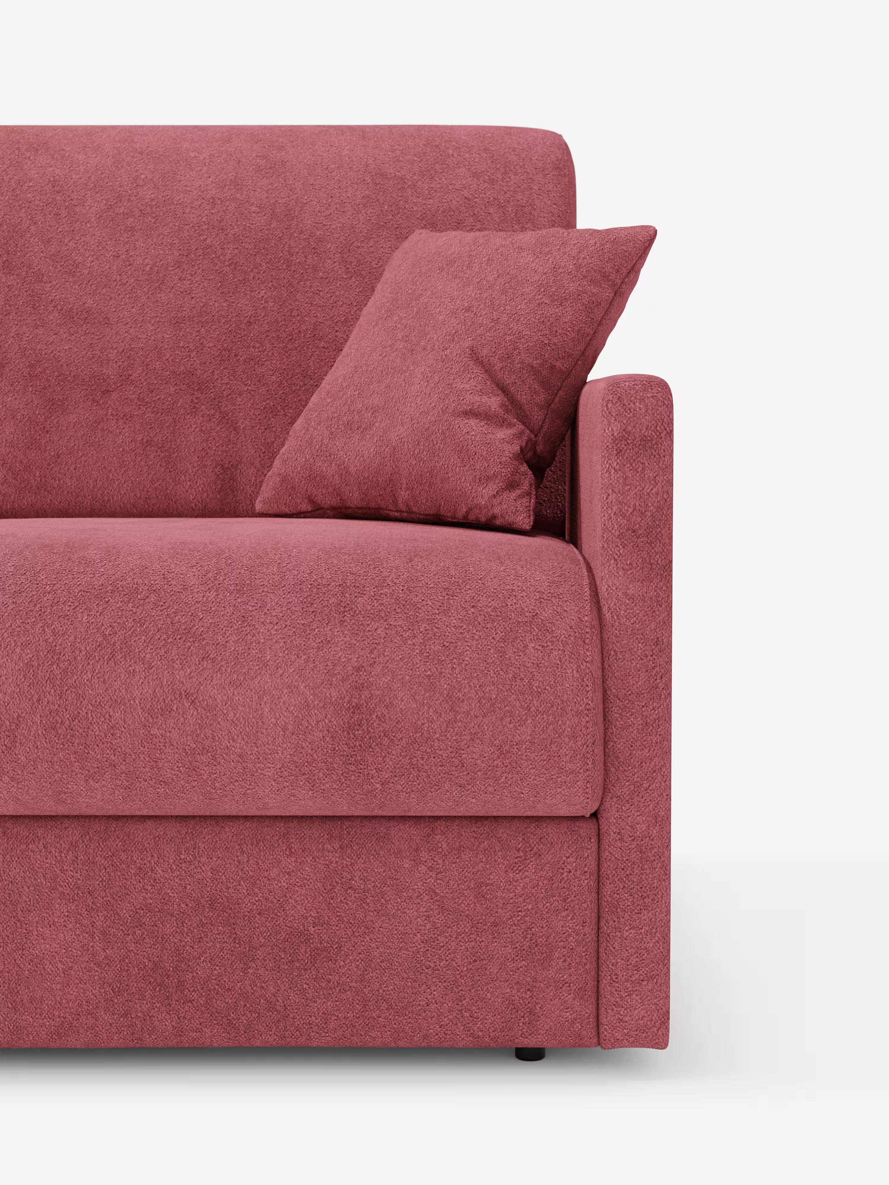Viene mostrato un primo piano del lato destro del divano letto Tommy a 2 e 3 posti matrimoniale di Divani.Store, rivestito in tessuto T33 simile al cotone, di colore rosa malva, morbido, con una trama particolare e resistente alle macchie. Il bracciolo, la seduta e lo schienale, dalle linee slanciate e sottili, risaltano su uno sfondo bianco a tinta unita, insieme a un cuscino coordinato. Il divano è completamente sfoderabile per facilitare la pulizia.