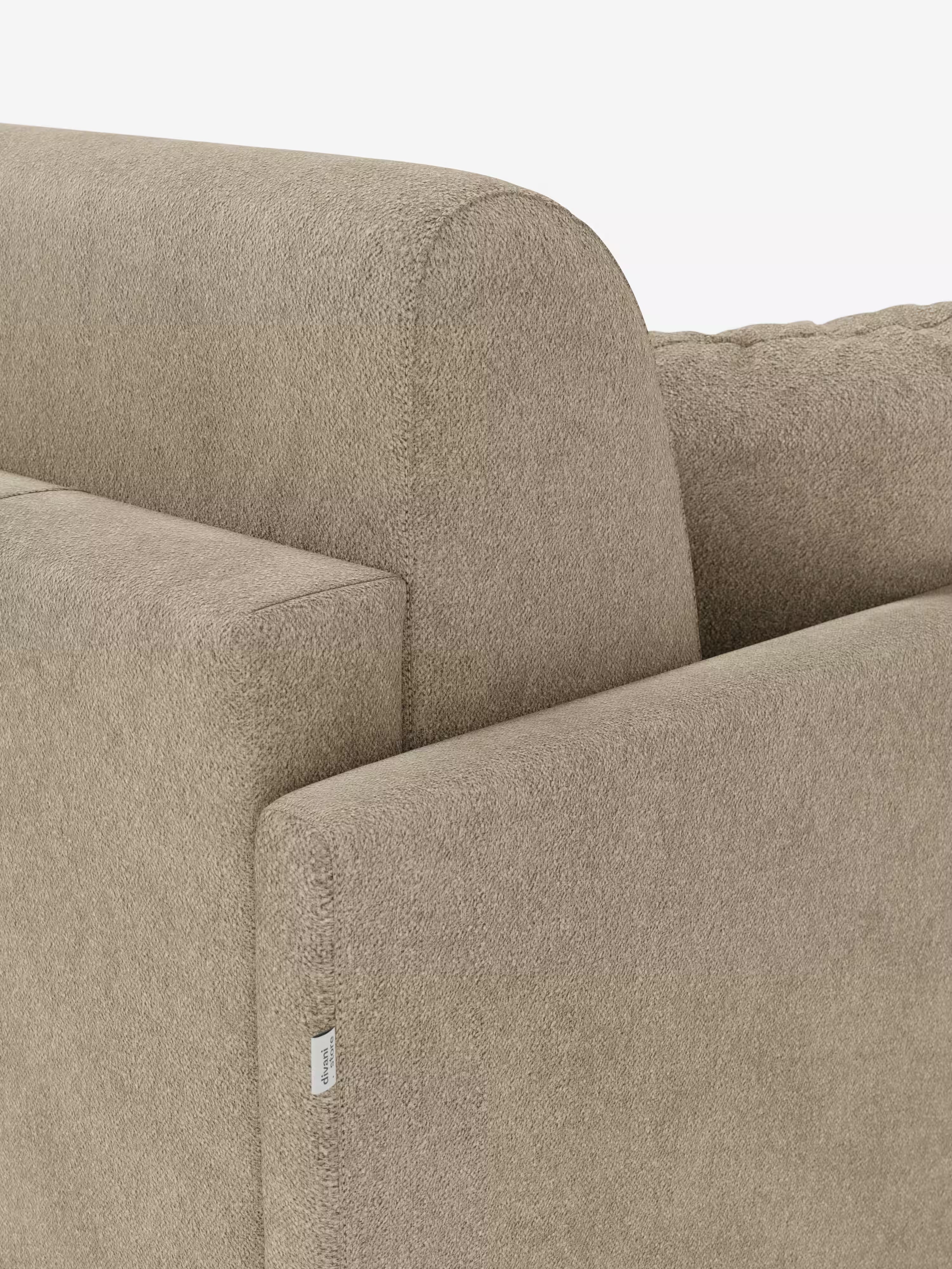 Primo piano del divano letto Tommy Divano a 2 e 3 posti matrimoniale color beige di Divani.Store, realizzato in tessuto T33 smacchiabile effetto cotone. L’immagine mette in risalto i braccioli sottili, lo schienale e una piccola etichetta bianca sulla cucitura. La trama morbida e leggermente felpata risalta sullo sfondo bianco a tinta unita, sottolineando le linee pulite del divano e il suo design moderno, completamente sfoderabile (100% sfoderabile).