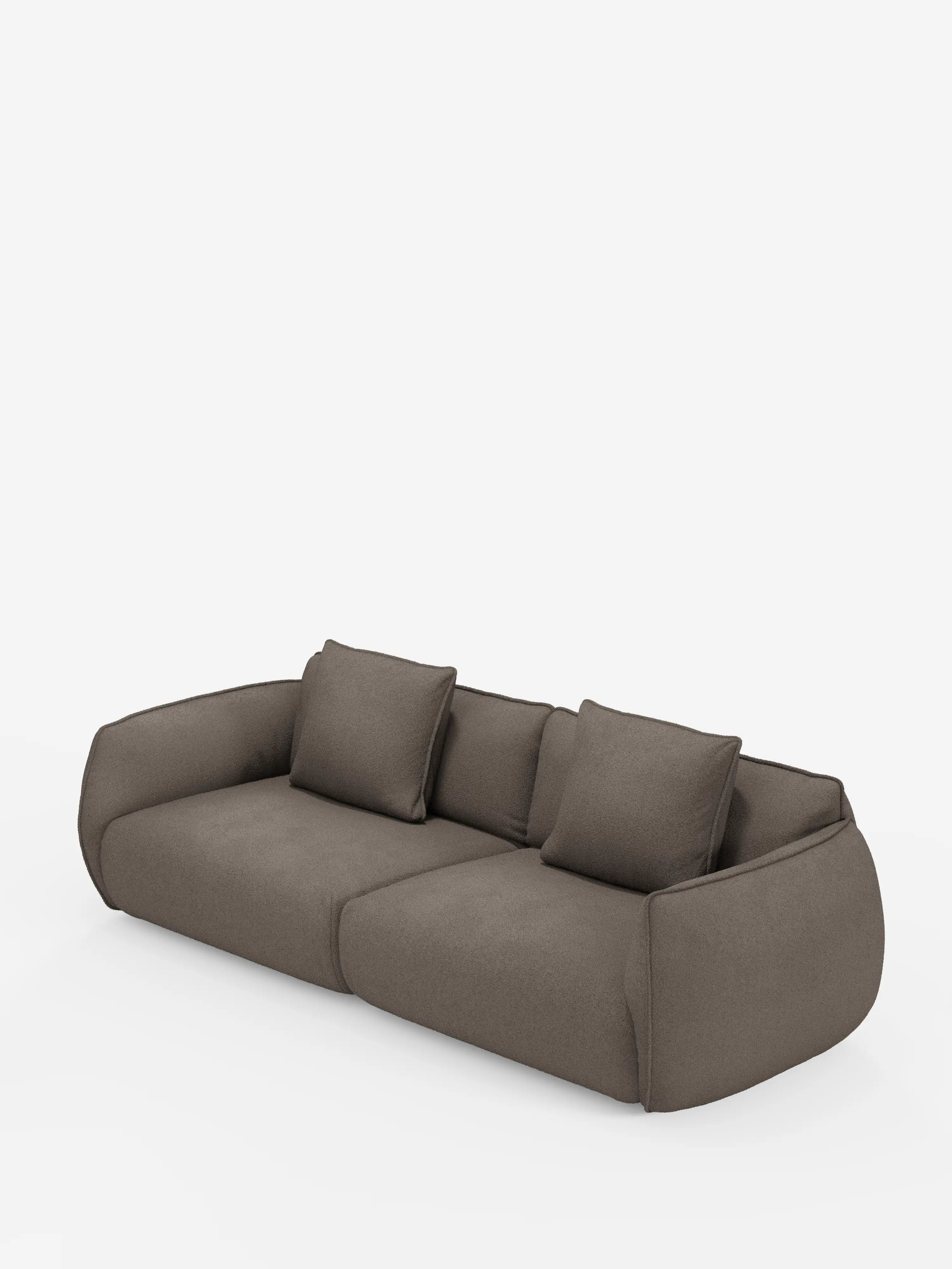 Un moderno divano Nimbus a 3 posti, dal profilo basso e di colore marrone, modulare e componibile di Divani.Store, caratterizzato da spigoli arrotondati e da un rivestimento in morbido tessuto effetto cotone resistente alle macchie. Due ampie sezioni di seduta e tre cuscini quadrati abbinati poggiano contro lo schienale leggermente inclinato, il tutto su uno sfondo bianco a tinta unita.