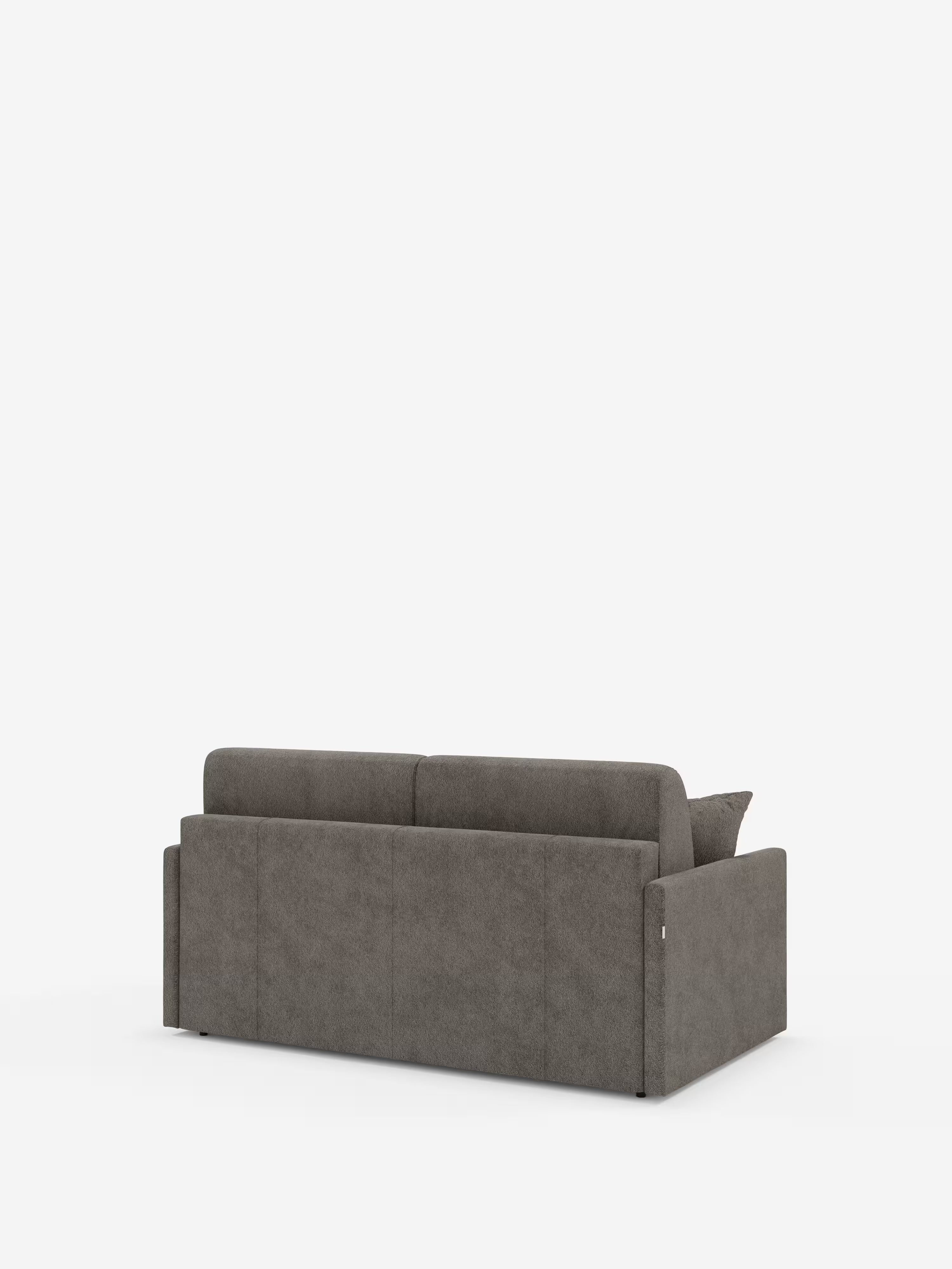 Il divano letto Tommy Divano a 2 e 3 posti matrimoniale, in grigio e dal design moderno, di Divani.Store, è ripreso da dietro e presenta linee pulite, un rivestimento liscio in simil cotone (tessuto T33, 100% sfoderabile e antimacchia) e braccioli rettangolari bassi. Sulla destra è visibile un unico cuscino, mentre il divano poggia su gambe corte e scure su uno sfondo bianco a tinta unita.