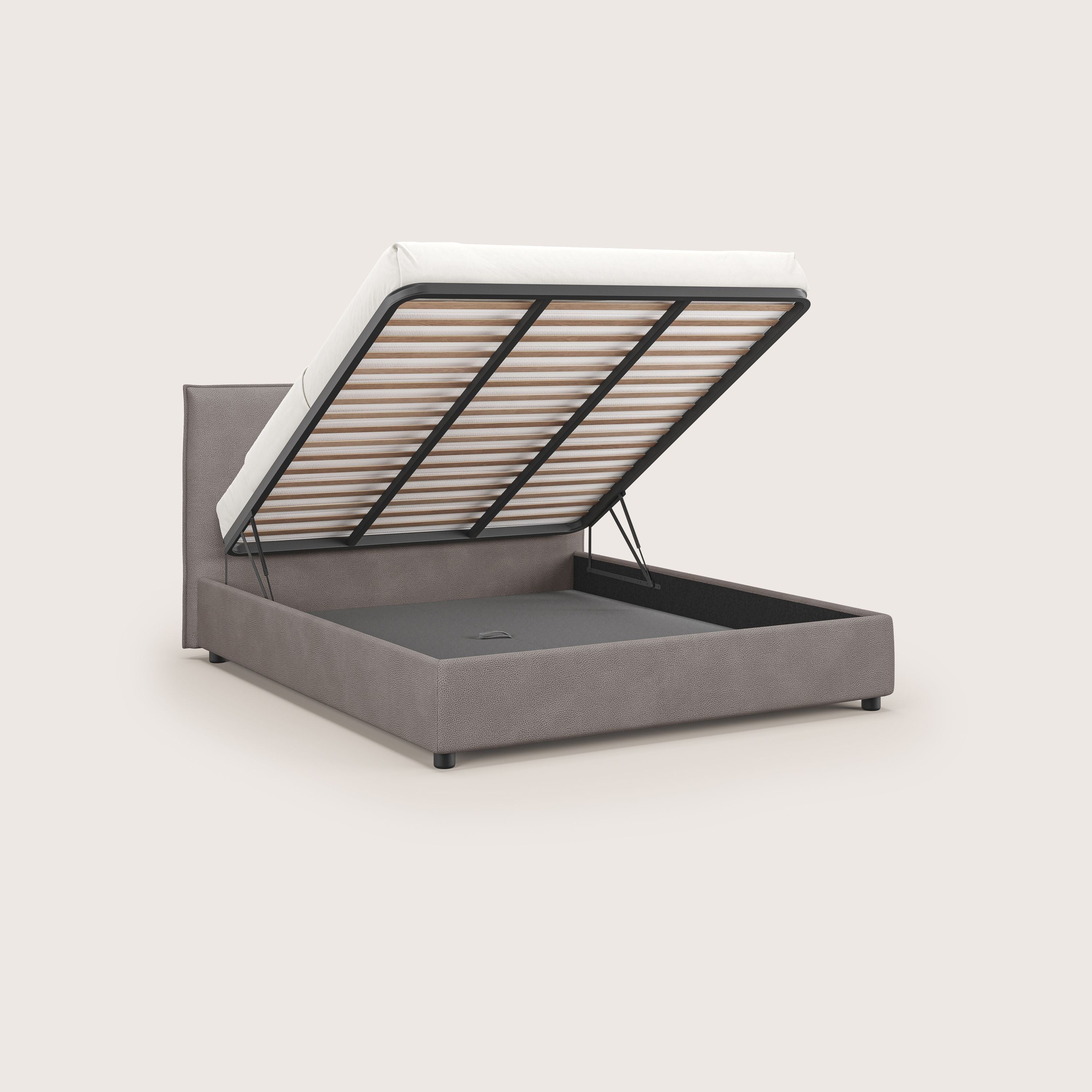 Il letto contenitore Nina di Letti.store è caratterizzato da un design minimale, da una microfibra antimacchia color tortora, da una base a doghe sollevabile per riporre gli oggetti e da una semplice testiera rettangolare, su uno sfondo chiaro.