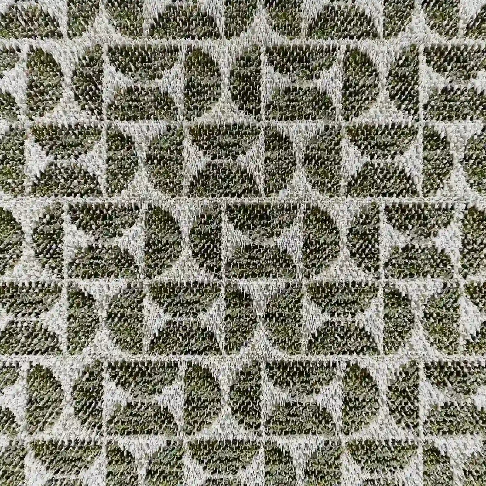 Primo piano del cuscino decorativo Naxos 45x45 in lino di Divani.Store: semicerchi e triangoli verdi creano un’elegante griglia geometrica su sfondo beige, conferendo un forte contrasto e uno stile deciso a questo raffinato cuscino d’arredo.