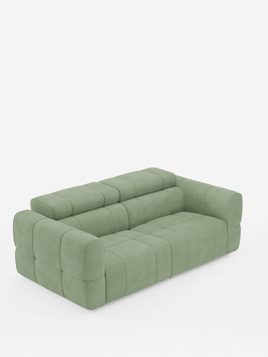 Un divano modulare Giotto a 3 posti color verde salvia, con poggiatesta reclinabili e funzione relax elettrica opzionale, rivestito in tessuto smacchiabile T23, caratterizzato da un motivo trapuntato geometrico a profilo basso su sfondo bianco.