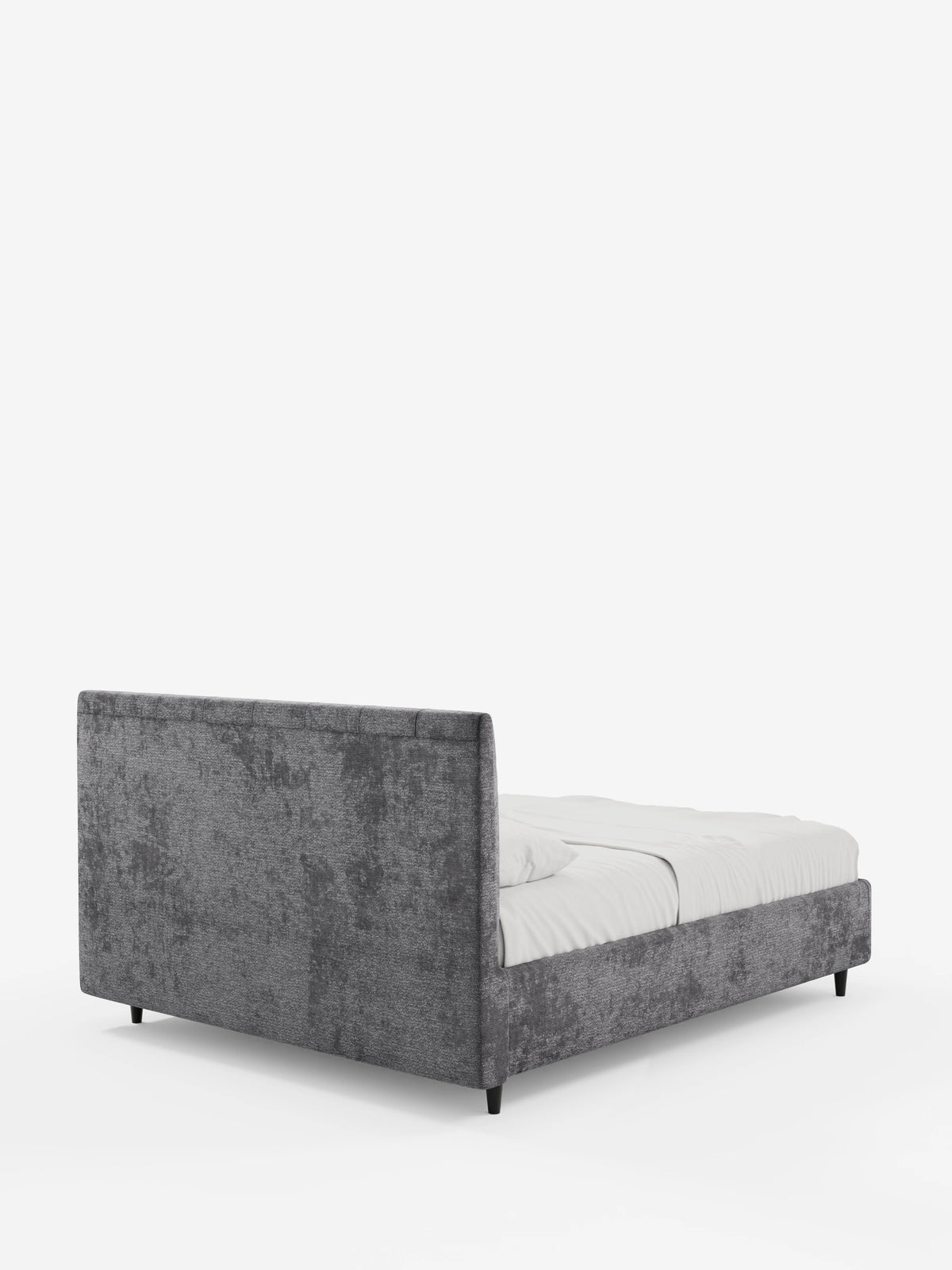 Il letto imbottito ONYX con contenitore e testiera verticale in tessuto certificato Oeko-Tex® è un letto imbottito grigio antracite con una testiera alta e rettangolare, un materasso bianco e sottili gambe nere, visto dall'angolo posteriore.