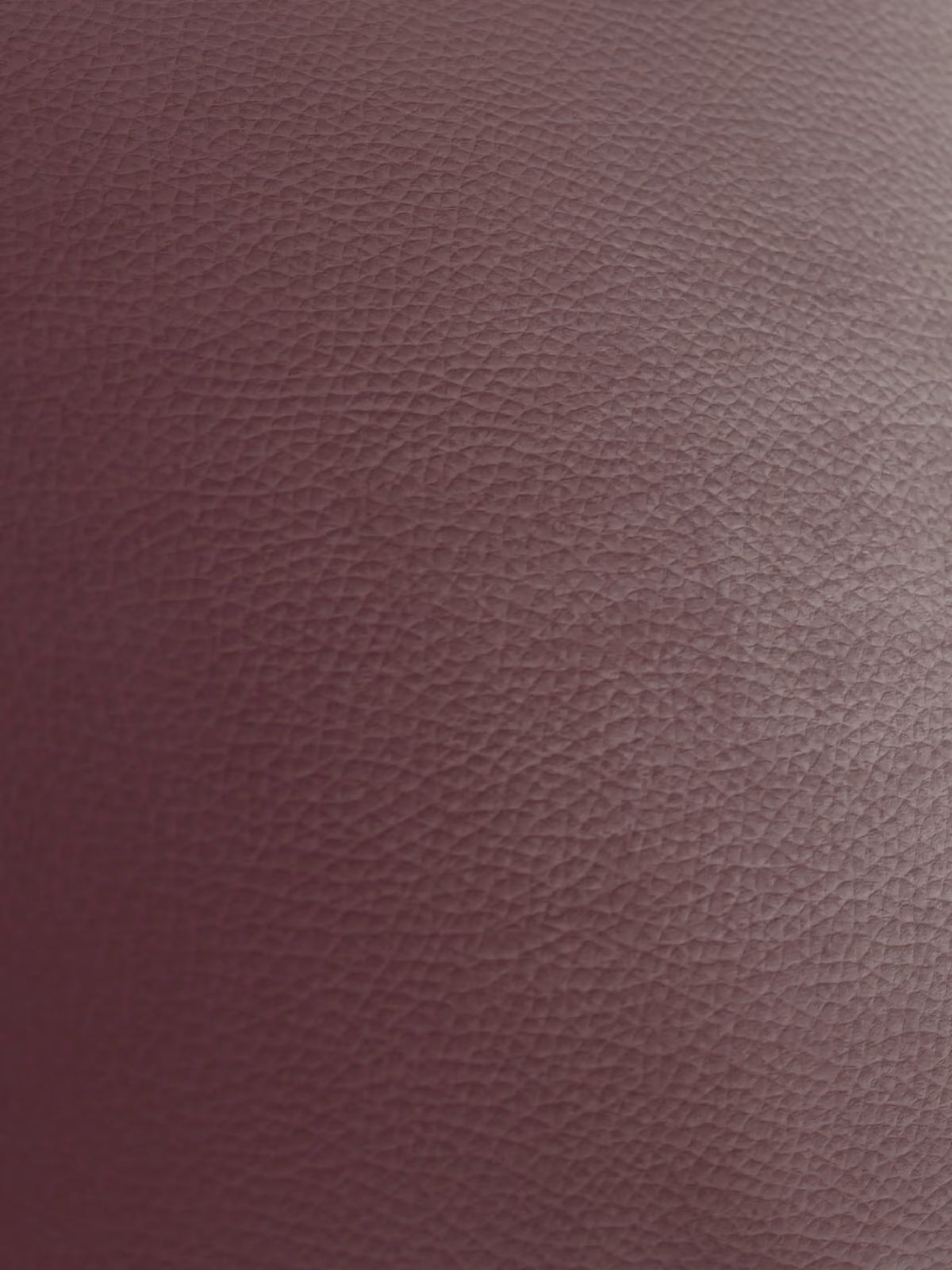 Primo piano della vera pelle marrone rossiccio con texture del modello Chester 4 Posti 3 sedute in Vera Pelle – Chesterfield Capitonné Artigianale di Divani.Store. L'immagine mostra un motivo dettagliato costituito da piccole granulosità in rilievo simili a ciottoli, con un'illuminazione che accentua la lussuosa trama della pelle — iconica dei classici modelli di divano Chesterfield — creando una lucentezza delicata e una profondità visiva. Nell'immagine non sono visibili altri oggetti o elementi.