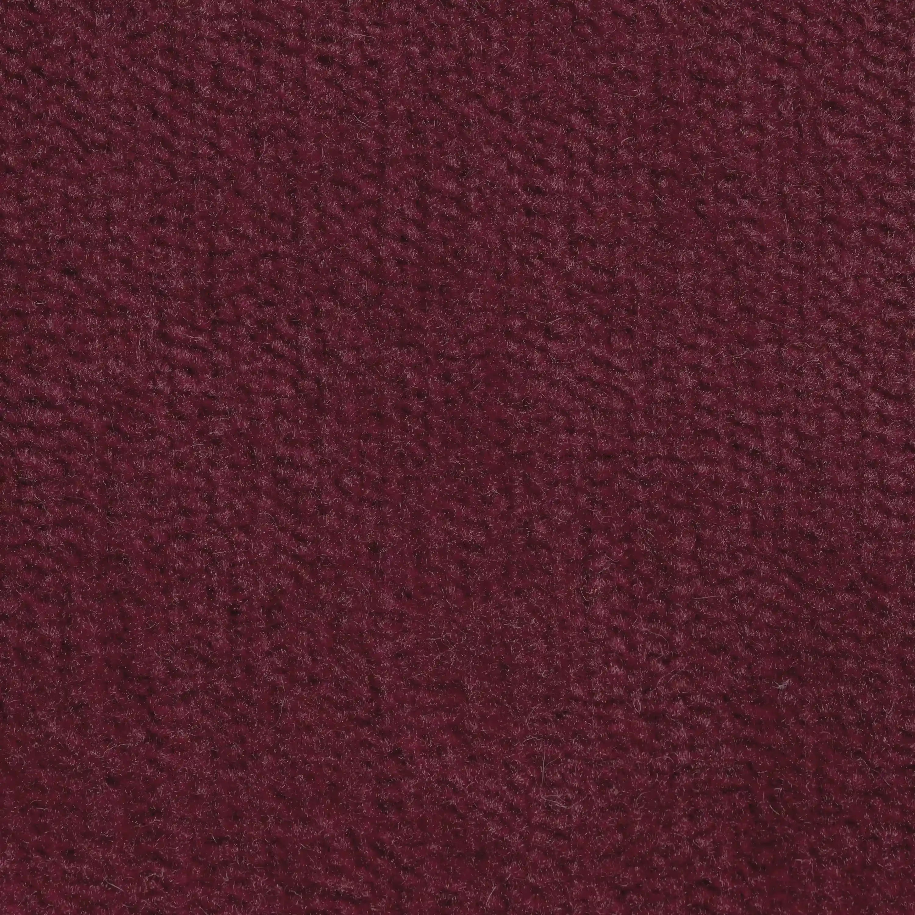 Una vista dettagliata del tessuto T31, morbido e antimacchia, in un ricco colore bordeaux, presente sul Monarch Divano angolare con penisola e Relax Elettrico con poggiatesta reclinabili di Divani.Store- La sua texture aggiunge comfort ed eleganza a qualsiasi spazio.
