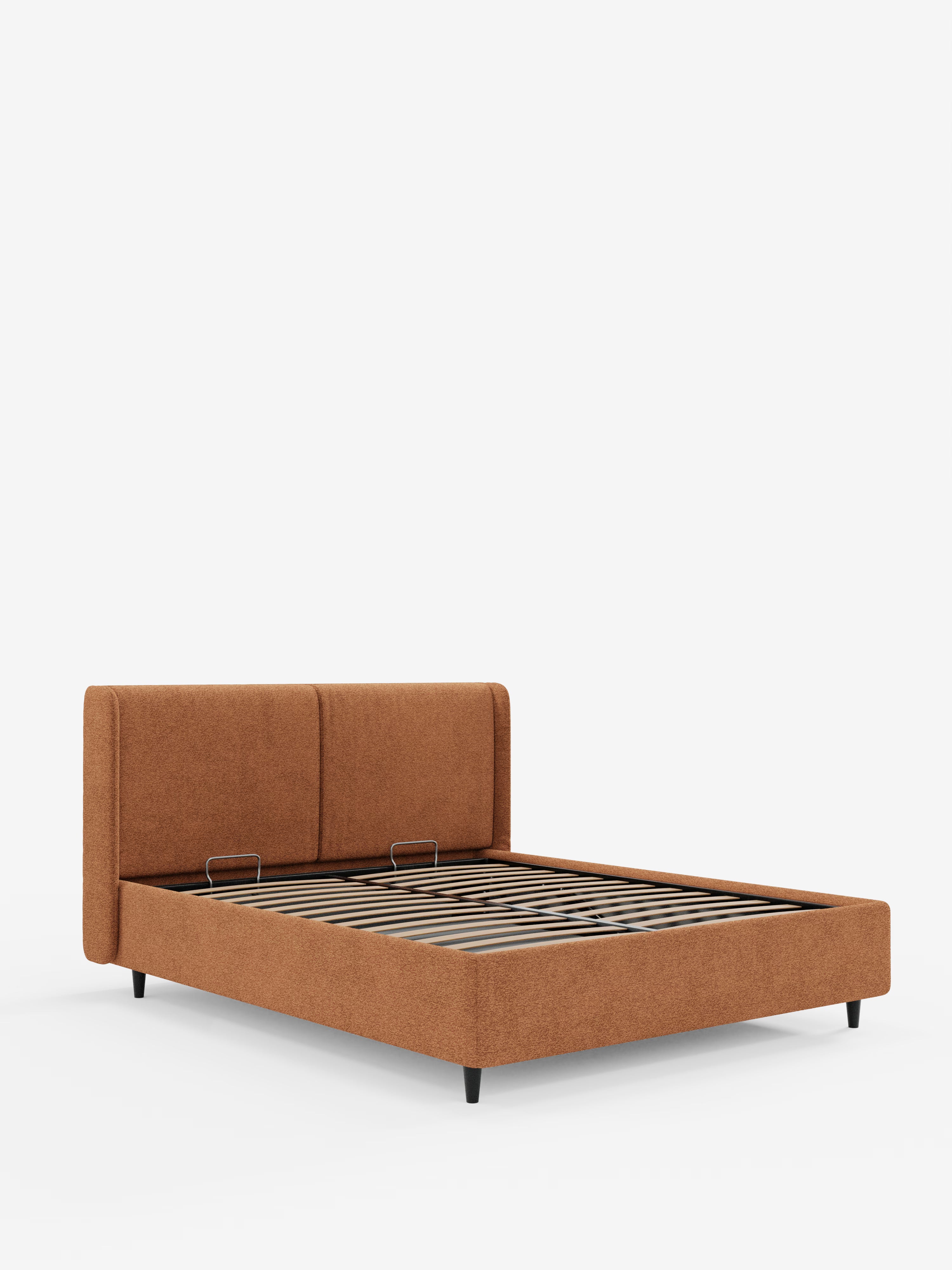 Un letto di design VALKIRIA moderno e dal profilo basso, con contenitore e testiera avvolgente, firmato Letti.store, rivestito in tessuto marrone certificato Oeko-Tex® con due cuscini imbottiti sulla testiera, doghe in legno e gambe corte nere. Caratterizzato da un design contemporaneo, il letto è raffigurato su uno sfondo bianco a tinta unita, visto dall’angolo anteriore sinistro.