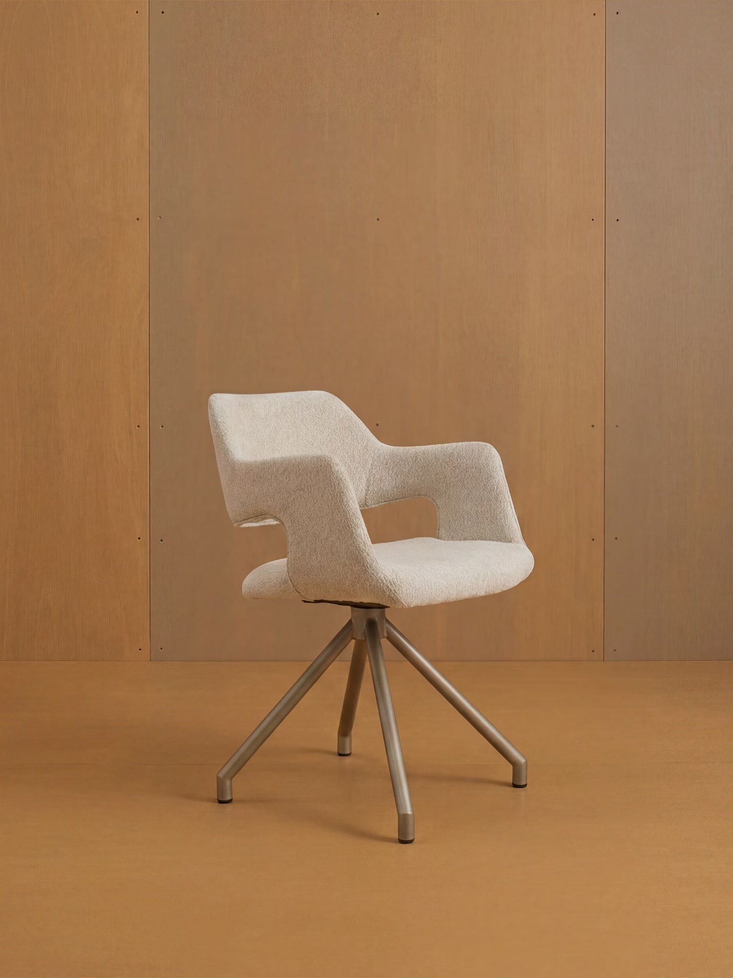 La sedia imbottita di design Zefira con braccioli di Divani.Store è caratterizzata da un tessuto effetto cotone, fianchi aperti e una robusta base in metallo color champagne: ideale per valorizzare qualsiasi ambiente minimalista con uno stile moderno.