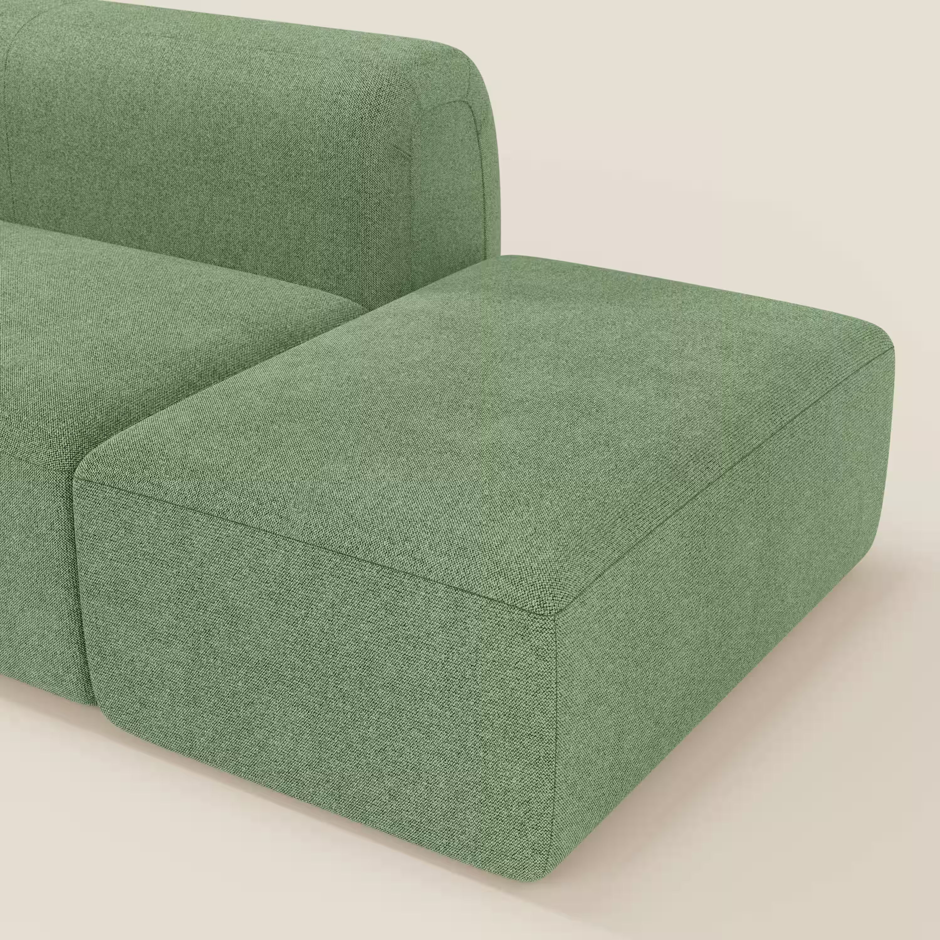 Primo piano del BonBon Divano componibile di Divani.Store in tessuto smacchiabile T23 menta, con pouf terminale. Il suo design moderno e minimalista si distingue per le linee morbide e gli angoli arrotondati su uno sfondo chiaro.