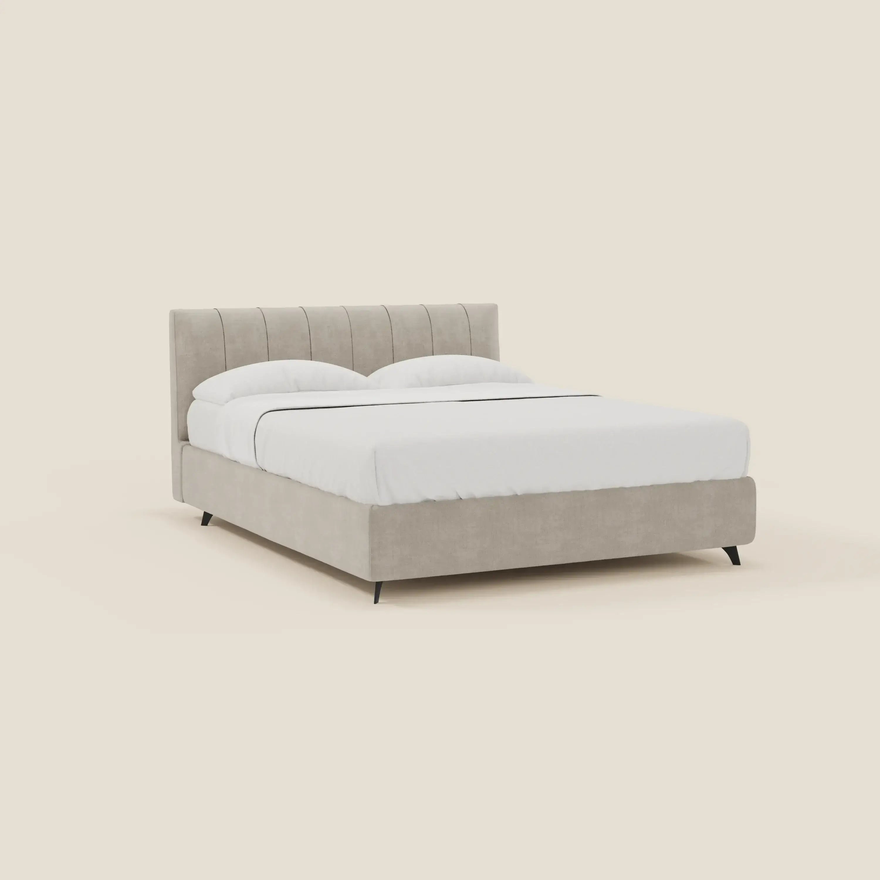 Un letto contenitore Bogart Edizione Grande Fratello di Letti.store, rivestito in tessuto T22 panna sfoderabile e antimacchia, con testata trapuntata e gambe angolari nere, è realizzato in modo ordinato con biancheria da letto bianca e due cuscini su uno sfondo crema chiaro.