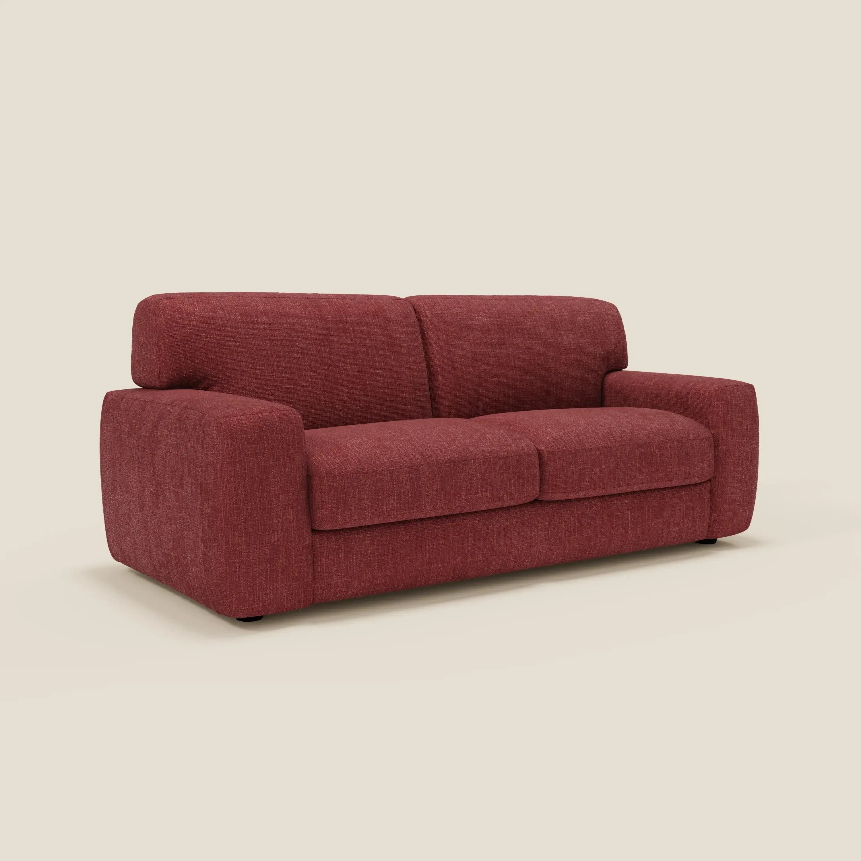 Cloud Divano letto materasso H17 cm di Divani.Store è un moderno biposto rosso con un morbido tessuto impermeabile T06, cuscini soffici, ampi braccioli e una texture sottile. Le gambe corte appena visibili ne esaltano il look elegante su uno sfondo beige.