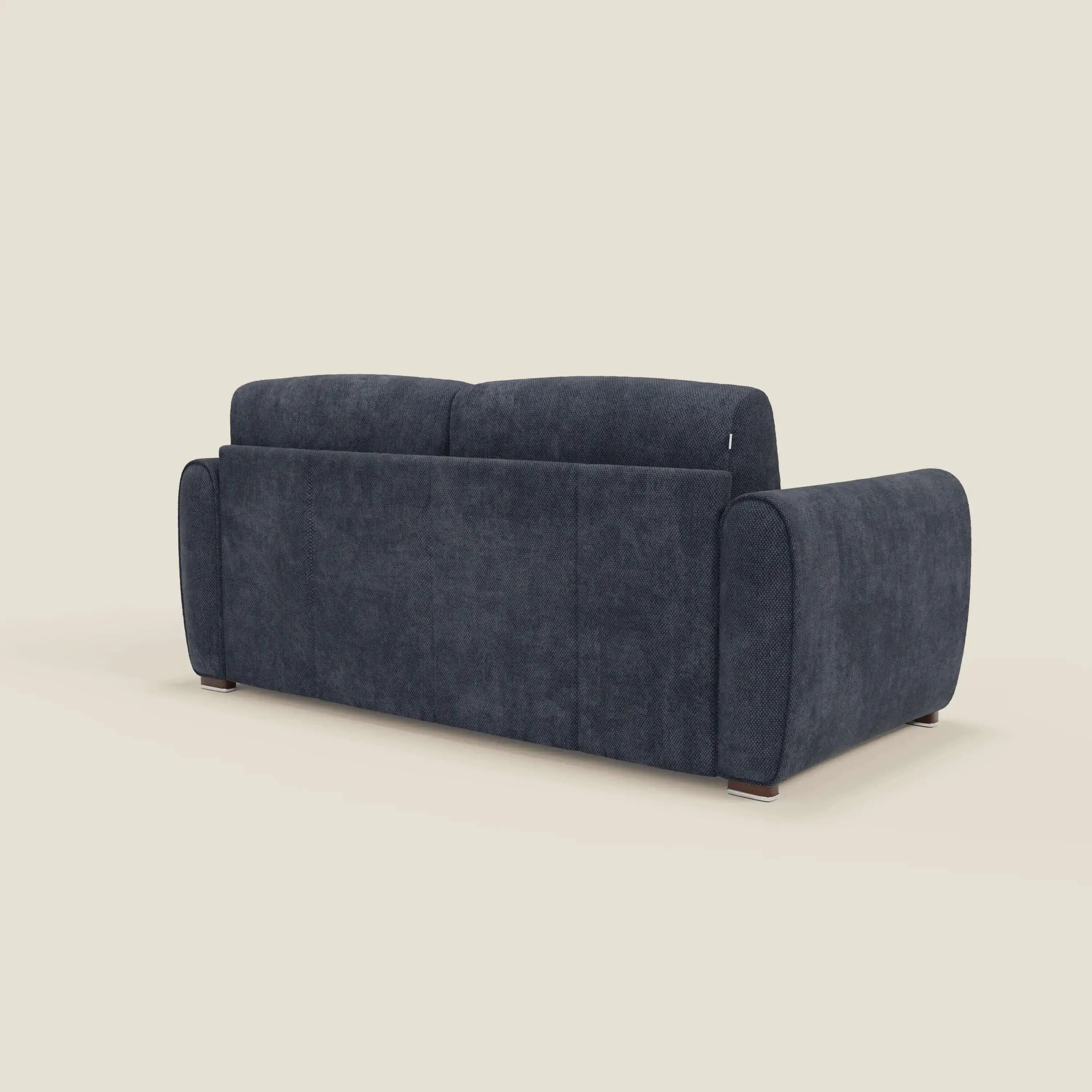 Il Kaleo Divano letto moderno di Divani.Store, in tessuto impermeabile blu navy T26 e con materasso H17 cm, è mostrato da dietro su sfondo beige; ha ampi braccioli, schienale alto e gambe corte che esaltano il design contemporaneo.
